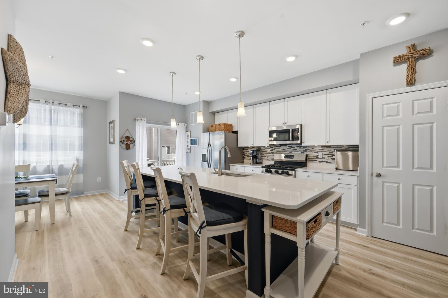Beautiful Upgraded Townhome in a Prime Location

Enjoy the perfect blend of space, style, and convenience in this exceptional four-level townhome, ideally located for easy commuting and close to shopping, dining, and everyday essentials.

This spacious home features numerous upgrades, including a stunning oversized kitchen island, quartz countertops, designer backsplash, stainless steel appliances, and luxury vinyl plank flooring throughout the main living areas. The open-concept layout offers abundant living space, with a large living room and dining area that comfortably accommodates six or more guests.

A unique fourth-floor level provides incredible flexibility, making it ideal for a home office, guest suite, or potential fifth bedroom. This level includes its own full bathroom, living area, and walkout deck, creating the perfect private retreat. At entry level this town house has a finished bedroom and bath which is unique, most units don't have a finished bedroom and bath.

With 4.5 bathrooms, this home is designed for comfort and convenience. The laundry room is thoughtfully located on the bedroom level, making everyday living easier.

Additional highlights include:
- Four level of living space that feels more like a single-family home.
-Spacious primary suite and generously sized bedrooms.
-Two car Garage plus, two car parking pads.
- Modern finishes and upgrade throughout.

Residence enjoys outstanding community amenities, including a community pool, kayak storage, and a pier for water enthusiasts. Conveniently located near target, food lion, and Starbucks, restaurants, and other popular retailers, this home offers everything you need just minutes away.

Don't miss the opportunity to own this beautifully upgraded townhome with exceptional space, flexibility, and amenities in a highly desirable location.