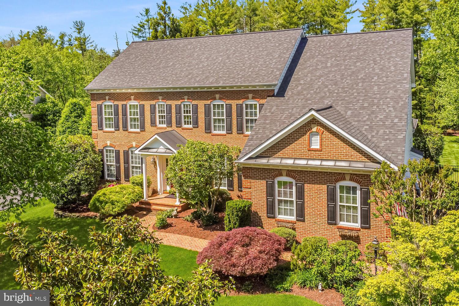 Discover the serene elegance of Quail Pond Estates with the Potomac model by NV Homes—a distinguished colonial masterpiece offering an extraordinary living experience. This impressive five-bedroom, five-and-a-half-bathroom home spans over 6,500 square feet of luxurious living space, set on a prime .64-acre lot surrounded by lush, mature landscaping that showcases exceptional privacy and beauty.  
<br><br>
From the moment you arrive, the home’s stunning brick facade commands attention, complemented by a newly resurfaced driveway and new roof with architectural shingles, enhancing its curb appeal. The property’s mature trees and meticulously maintained gardens create a verdant retreat, embodying timeless charm and a welcoming ambiance. This residence is a celebration of luxury, comfort, and sublime outdoor living.  
<br><br>
Step inside to a world of refined elegance, where open living spaces are adorned with intricate moldings and exquisite trim work that highlight the architectural brilliance throughout. Gleaming hardwood floors lead you through the generous foyer, formal living and dining rooms and into the heart of this home.    
<br><br>
The gourmet kitchen is designed for functionality and style, featuring a spacious granite-topped island with seating and storage, perfect for meal prep and casual dining. Chefs will delight in the gas cooktop and double oven, which facilitate all culinary endeavors. Ample granite counters, complemented by a stylish tile backsplash, and surrounded by upgraded cabinets, ensure maximum storage and a sleek appearance. This kitchen is not only a cook’s dream but also a central gathering spot for entertaining and everyday living.  
<br><br>
Adjacent to the kitchen, a sunlit morning room with soaring cathedral ceilings provides an inviting space for informal dining. The seamless integration of entertainment and relaxation is beautifully showcased in the spacious family room, featuring a warm gas fireplace as its centerpiece. For year-round enjoyment, a fully enclosed, insulated porch serves as a tranquil retreat, perfectly complementing the home's luxurious ambiance. Additionally, the main level boasts a functional mudroom and a home office, adding layers of practical elegance to the home’s thoughtful design.  
<br><br>
The journey continues upstairs to the exquisite primary suite, which features a sitting area framed by elegant columns and a tray ceiling, leading into a lavish bathroom with a deep soaking tub and dual vanities. The architectural design includes a unique 'gallery' around the central staircase on the upper level, which enhances the open, airy feel and provides access to all rooms. Completing the upper level is an en-suite bedroom with full bath, and two additional bedrooms sharing a Jack-and-Jill bathroom. Additionally, this highly desirable floor plan encompasses a finished attic with recreation room, bedroom, and a full bathroom.  
<br><br>
The lower level of the home is equally impressive, with a huge recreation room, guest suite, and full bathroom, all with new carpet and paint. It’s the perfect setting for hosting guests or family movie nights. The incredible outdoor space is highlighted by a large flagstone patio with outdoor kitchen and bar. Rarely available in the heart of Ashburn, this large lot encompassed by mature trees, provides ample space for outdoor activities or even a future swimming pool. The practicality of this estate is rounded out by a three-car side-load garage, adding to its refined utility.  
<br><br>
Perfectly positioned for convenience, this estate is less than a mile from the Silver Line metro, offering quick access to commuter routes and blending suburban tranquility with effortless urban access. Located in sought-after Loudoun County, minutes from schools, shops, restaurants, and entertainment venues, this home at Quail Pond Estates represents the pinnacle of sophisticated living—where luxury meets comfort in every detail.