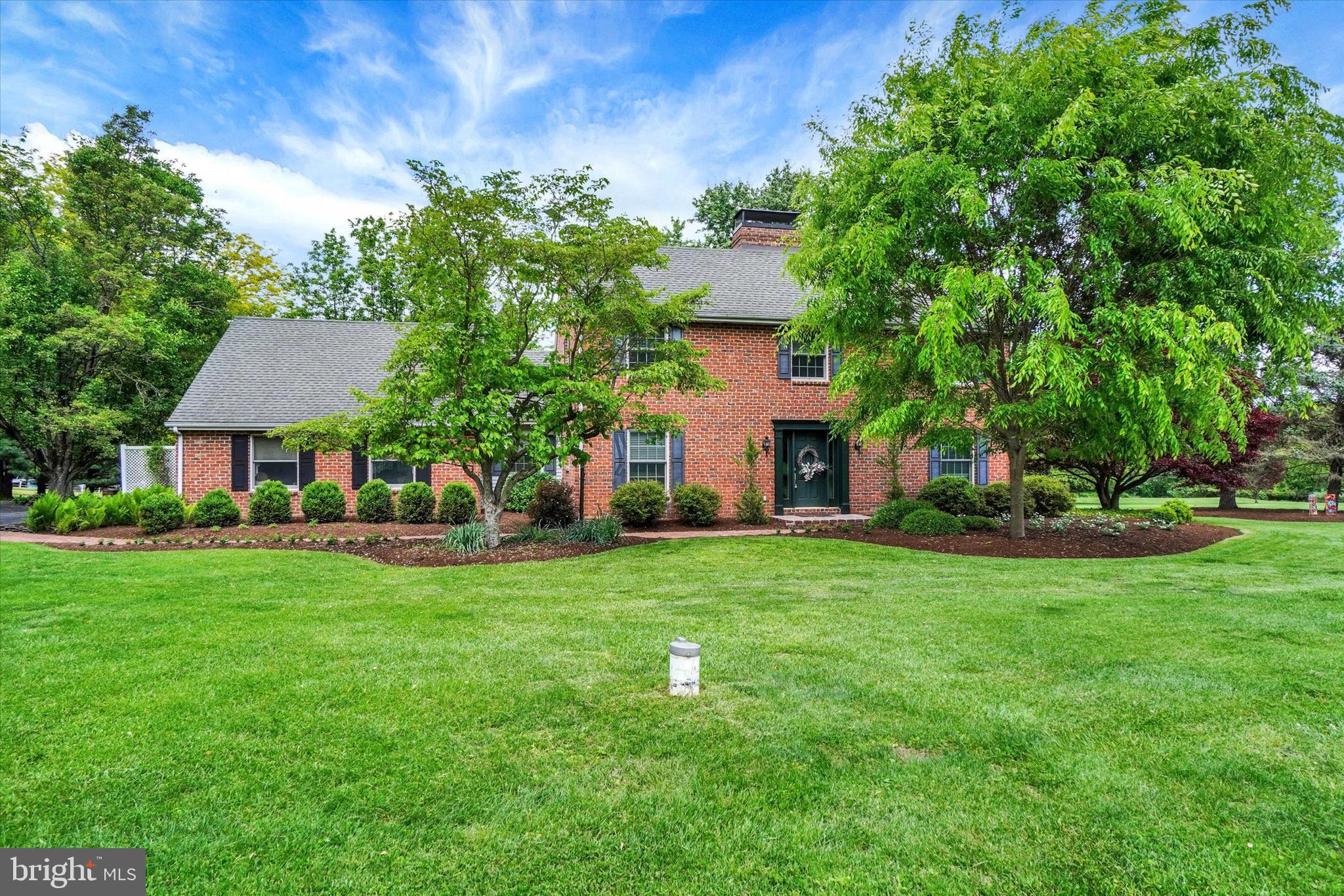 Set back a long driveway in the middle of 5.5 acres of peaceful privacy you'll discover this one owner custom built all brick 2 story Salt Box style home boasting 4 Bedrooms and 3.5 bathrooms affording space for the entire family. This well thought out floorplan is inclusive of a  first floor primary suite and a private guest suite. This first time offering is located in one of York County's most desirable locations based on an abundance of peace and privacy and minimal traffic , yet only minutes from all major traffic routes and shopping venues.  As for the special features of this home, there are many. Let's start in the gourmet kitchen , which has been nicely updated to include custom cabinetry, gorgeous granite tops, large spacious island, custom gas stove top, built in double oven, built in Bosch microwave and a Brick Fireplace for added ambiance. Off the kitchen are 2 cozy spaces to be used as either dining or sitting rooms, whatever your fancy. Next let's move to the large first floor family room that features a wall of custom built in cabinetry, a wet bar, warm hardwood floors and a very nice exclusive in home sound system that will stay for the new owners enjoyment. Adjacent to the family room is a workspace/ office area plus a laundry room and powder room, both conveniently placed for ease of access. Still on the main floor, discover the primary owners suite boasting a newly updated bath and ample sized walk in closet plus beautiful hardwood floors. On the second floor is an open loft looking over the kitchen area plus 2 more private bedrooms , both with hardwood flooring and a full bath. Don't forget the very private guest suite with it's own bath with heated floors, sure to please the tired traveler who seeks shelter from the storm, or just your own overnight guests or family member! In addition to all this, there is finished space in the lower level for games, exercise, etc. which also includes extra kitchen space for canning or entertaining. For your vehicles and yard equipment, there is a large 3 bay garage with a full second story workshop, perfect for the craftsman or gardener. No worries here  on the major systems of this well maintained property as the roof on the house and garage were replaced in 2009 with 50 year shingles, the heating system has been replaced and upgraded to a 4 zone state of the art propane fired super efficient hot water design in 2025, the original septic system has been completely replaced with a modern peat tank filtering system, the hot water heater replaced with a Rheem Performance Platinum Hybrid Heat Pump Water Heater and the well pump was replaced in 2025. Did I mention that all windows were upgraded to Andersen Series A units? There is a 1000 galloon underground propane tank that is owned by seller, allowing you to choose the propane supplier you prefer. To top it all off, there is lush landscaping and thoughtfully placed flower beds for the plant and gardener lover. All in all, this is a rare opportunity to obtain a well built, well maintained and upgraded family home offering acreage, privacy and convenience in one package. Come see for yourself, you won't want to leave.