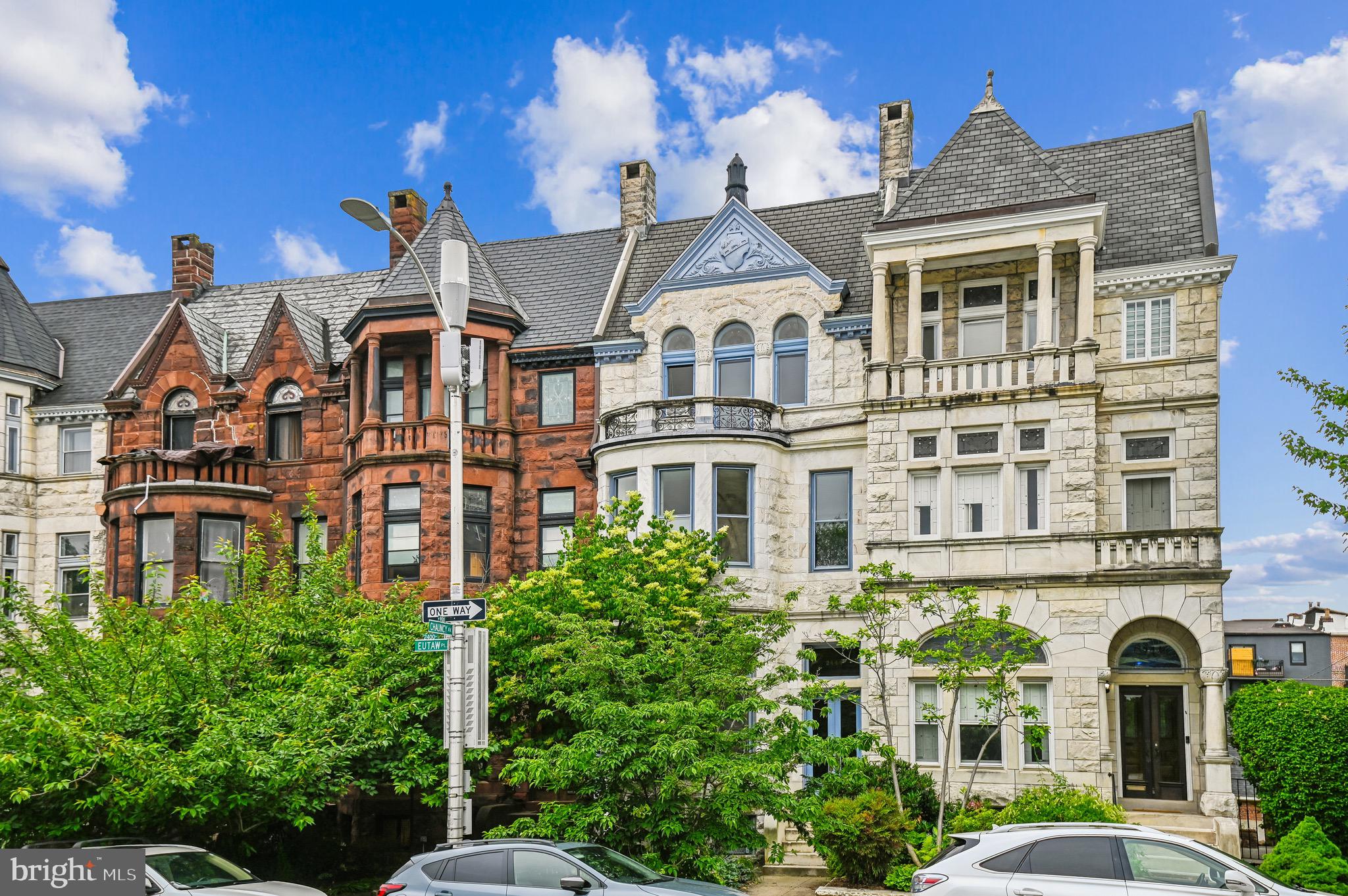 Discover this remarkable Romanesque Victorian residence in the highly sought-after area of Historic Reservoir Hill. This 4-5 bedroom, 3.5 bathroom home is characterized by an exquisite stone facade, and is adorned with a wealth of preserved original details, showcasing craftsmanship that truly stands the test of time.

As you enter, you are greeted by a grand foyer featuring a pier mirror, a handcrafted stairway, and elegant parquet flooring that flows seamlessly throughout the home. To your left, the formal living room captivates with its wood-burning fireplace, pocket doors, and stunning stained glass, revealing the incredible architectural detail that remains present in every inch of this magnificent space.

Adjacent to the living room, you'll find a gracious sitting room highlighted by another grand pier mirror. This area perfectly separates the living and formal dining rooms, which boast a built-in china and crystal cabinet, an antique gilded mirror, and another inviting wood-burning fireplace. Picture yourself entertaining up to 14 guests as you share memorable meals and conversations in this nostalgic setting.

Continuing down the hall, you will discover a laundry room and a half bath, as well as an updated kitchen designed for both functionality and style. This chef's haven includes a large island with seating, ample custom cabinetry, open shelving, top-of-the-line appliances, and a back staircase that leads to the second floor. The kitchen benefits from large windows that pour in natural light, and just outside the back door, a spacious, sun-drenched deck awaits, offering the perfect spot for additional entertaining or for gardening enthusiasts eager to cultivate herbs, vegetables, and flowers.

Moving to the second floor, the large primary bedroom features its own wood-burning fireplace, accompanied by a sitting/dressing room and a generously sized den with an elegant decorative fireplace, along with a full bathroom. Down the hall, bedroom 2 is equipped with built-in bookshelves and a full en-suite bath, providing a private retreat for family or guests.

On the third floor, you'll find an ideal setup for in-law or au pair accommodations. Bedroom 3 is graced with a decorative fireplace and built-in shelving, while a sitting transition room leads to bedroom 4, which also features a decorative fireplace and a full bathroom. This level is versatile, containing a spacious kitchen area that could easily be converted into a fifth bedroom.

The expansive, full walkout basement offers endless potential, with high ceilings, plumbing ready for a full bathroom, and generous storage space to accommodate all your needs.

Completing this historic masterpiece is a highly coveted 2-car garage situated at the rear of the property, which includes a convenient doorway providing direct access to the lower level and the kitchen.

Located directly across from Beth Am and just a block away from Druid Hill Park, this home is positioned in a neighborhood known for its architectural significance and its vibrant sense of community. With proximity to major universities, public transport, and key transportation routes, this property represents a rare opportunity to own a unique piece of history in one of Baltimore's most cherished neighborhoods.