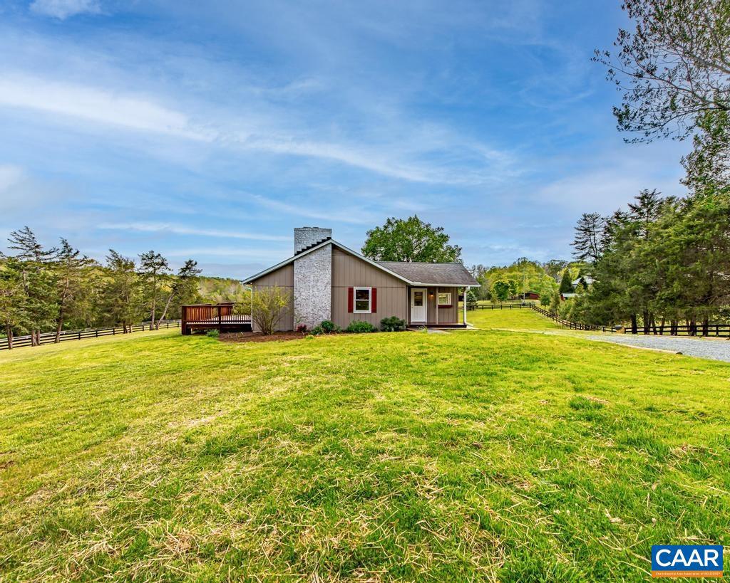 A short, pretty drive from downtown, this deceptively large home is renovated and move-in ready. There's an all-new kitchen, upgraded electric, new lighting, refinished floors, and fresh paint throughout. Fireplaces were recently cleaned and inspected. Three new decks including a huge one off the great room overlook the quiet beauty of surrounding horse farms. The partially finished, walk-out basement has good ceiling height, a second wood-burning fireplace, and is plumbed for a full bathroom. Propane furnace, replacement windows, and roof new since 2015. Fiber internet is available.,Granite Counter,White Cabinets,Fireplace in Great Room