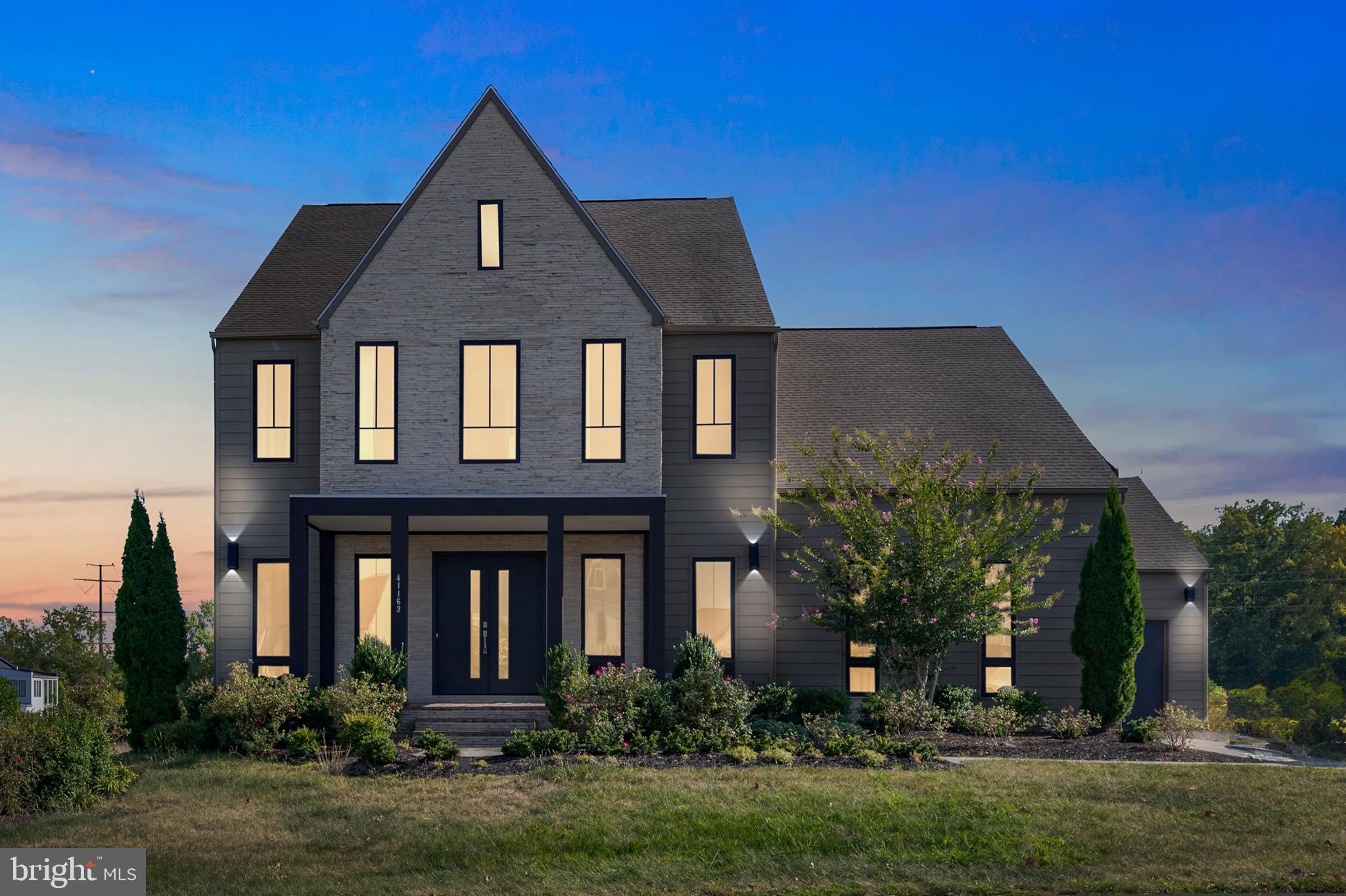 CHECK OUT THE AMAZING NEW PRICE!!!  (Offer deadline is Wednesday, 10/25 @ 5pm).
With almost 6,000 sq ft of luxury finishes, this 5 bedroom, 4 full and 2 half bathroom house is calling you home! According to Studio Piet Boon...this contemporary "home boasts an abundance of natural light, rich materials that correspond well with their surrounding environment, and artistic nuances that are found around every corner."  World renowned Dutch architect designed the interior and exterior of just 22 homes in the award winning Willowsford community.  Luxurious yet welcoming features surround you the minute you walk in the double doors, and continues throughout the three levels of this 5,814 sq ft DeKat model.  State-of-the-art sparkling kitchen with adjoining family room are the heart of the home.  Enjoy a formal meal in the striking dining room, breakfast at the waterfall island, a casual lunch surrounded by windows, an al fresco dinner on the oversized two-tiered deck, or grill your fresh catch on the spacious patio.  The main level also boasts a built-in office, au pair or in-law-suite, beautiful living room, butler's pantry, wet bar, modern gas fireplace, a powder room and mudroom.  Upstairs you will find the magnificent owner's suite filled with natural light, a sitting area, the walk-in closet of your dreams and a spa-style primary bath.  Three additional bedrooms, two more full baths and the laundry room finish off the oversized rooms on this floor.  The finished portion of the lower level is so large that you can let your imagination run wild.  Enjoy a casual conversation by the terrific gas fireplace, add a pool table, another dining area, a yoga or dance studio, and even a home theater or gym.  Another half-bath and a huge storage area finish off this level.  Did I mention a three car garage with two electric car charging outlets, a top-of-the-line security system, a whole house audio system and smart lighting throughout the house?!
Live the Willowsford lifestyle with two elaborate clubhouses, resort style pools, fantastic gyms, a 7-acre lake with boat house and fishing dock, dog parks, campgrounds and so much more!  Join your neighbors for community events, demonstration and teaching kitchens, volleyball games, and music at the amphitheater.  It is hard to believe that Willowsford -- a 4000 farm-to-table community, with its 300-acre farm, garden and market,   2000 acres of conservation, and miles of walking trails -- is less than 15 miles from Dulles International Airport and 35 miles from Washington DC.  Need a little space to clear your head...41163 Stella Run Lane is the place for you!