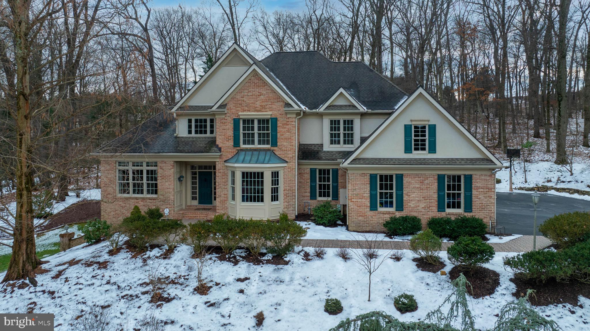 This elegant, inviting home features a timeless design for living and a peaceful, park-like setting on 1.68 acres with access to Rosenmiller Farm amenities of hiking trails, tennis courts, pond and more. From the moment you drive up to this 2 story Custom Brick home you will be impressed. The impressive interior showcases custom craftsmanship , striking architectural details, custom mill work, spacious and well thought-out floor plan with natural light throughout over 5000+ sq ft of living space, that has been meticulously updated  inside and out making this home move in ready. The first floor features all hardwood Brazilian cherry floors, a grand 2 story foyer,  dual stair cases, handsome 2 story great room with floor to ceiling windows, fireplace with custom tile surround, French doors opening to the rear patios, gardens and waterfall features, all seamlessly flowing into the well designed chefs kitchen with stunning granite counters, center island, breakfast bar, custom cabinetry, updated appliances a dining area with walls of windows and skylight. The first floor also offers a formal dining room  perfect for entertaining large gathering and access to a butler/bar, an additional  family room with vaulted ceilings and skylights off the kitchen area, and the first floor Primary suite  featuring  two walk in closets, a completed renovated primary bath with walk in shower, 2 separate sinks,  free standing tub with outside views to enjoy, tile floors and a separate water closet. The adjacent office/den has convenient private access from the primary suite as well as French doors to the foyer. Completing the first floor is a half bath on the first floor along with a large walk in laundry room with windows and storage, a hall of storage closets and entry to the fantastic 4-car heated garage with an additional half bath. The second floor showcases the home's aesthetics from balcony overlooks into the entire first floor, and offers secondary bedroom with an en suite bath and walk in closet, two additional large bedrooms with a shared bath providing but each bedroom with its own separate vanity and commode. Opposite the bedrooms, is a delightful office/music room with skylights, custom  cherry built-ins and inviting reading nook perfect for curling up with your favorite novel. The full, finished lower level provides another large family room with windows,  kitchenette, possible 5th bedroom, full bath, exercise room, storage and a flexible layout to suit your tastes.  The large work shop area is an added bonus, and includes double doors opening to the outside yard. The exterior grounds offer magnificent mature landscaping, updated brick walkways, patios and landscape lighting all in a very private setting embraced by mature trees. The large driveway with additional parking for guests is heated for your safety and ease.  The location of the home perfectly places I-83, Hospitals, Health care,  Schools, Colleges, Shopping, Golf Courses, Country Clubs, Parks  and more at your fingertips, and sits in York Suburban School District. A full list of the home's upgrades and amenities is available in the MLS or by request. This is just a wonderful home in a perfect setting and location. Don't miss it!