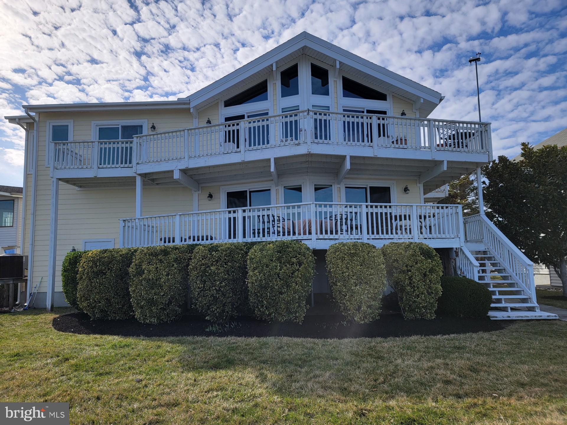 Welcome to 3 Clubhouse Drive, a stunning property located in the highly sought-after Ocean Pines community. Completely redesigned and rebuilt in 2012, this exceptional home is situated at the end of Clubhouse Drive, offering water views on two sides. Designed and meticulously maintained by its owner, a professional engineer, the property showcases a range of unique features and thoughtful details.

The breathtaking Primary Bedroom, located on the second level, boasts panoramic views of the St. Martin River, extending out to Assawoman Bay and the coastal skyline of Ocean City. The luxurious Primary Bathroom features a walk-in shower with a built-in seat and niches, perfect for relaxation. The second-level Great Room, gourmet kitchen with a gas stove and stainless-steel appliances, and dining area all feature soaring cathedral ceilings. 2-sliding doors open to a deck, and a TV over the gas fireplace conveys with the property. Additionally, you'll find another bedroom and a laundry room on this level.

The main entry level includes a door to the garage, two additional bedrooms, and a bathroom, along with an entertainment area complete with a wet bar, beverage refrigerator, and 2-sliding  doors leading to the lower deck. The home comes partially furnished, and all appliances are included, allowing you to begin enjoying it immediately with friends and family.

Recent upgrades include complete remodels of two out of three bathrooms over the past three years, newly installed carpeting, and fresh paint throughout most rooms in 2025. The oversized garage on the first level offers ample storage space, and a commercial-grade hydraulic elevator provides access to all three levels. Additional features include an unlimited tankless gas water heater, no-maintenance hurricane-resistant siding made of thick, PVC-based engineered material, Low-E, argon-filled windows and sliding doors, and a reverse osmosis system providing pure water in the kitchen, including an instant hot water system,

The home boasts one of the best views in Ocean Pines, with nearly every room offering water vistas. From the Primary Bedroom, you feel truly surrounded by water, while the upper deck offers a perfect vantage point to enjoy boat watching throughout the season. Located at the mouth of the primary canal leading into Ocean Pines North, you can relax in the shade while taking in the view.

Major upgrades were completed in 2024 to ensure the home complies with current FEMA flood regulations. The commercial-grade elevator has been professionally maintained, re-inspected, and certified to meet Ocean City’s commercial elevator codes. Additionally, a new foundation system was installed in late 2024, complete with a lifetime transferable stabilization warranty.

Live the "salt life" directly on the St. Martin River, with no bridges between you and the bays/ocean. Enjoy crabbing and fishing right from your bulkhead, recently replaced pier, along with a custom-designed, heavy-duty boat lift that previously supported a 32' power catamaran (11,000 lbs). Bulkhead maintenance is handled by the HOA, offering you peace of mind. Don’t miss the chance to own this truly one-of-a-kind property with spectacular water views and unparalleled upgrades.

The Ocean Pines Community offers a multitude of amenities throughout, including two golf courses, parks, and many restaurants.