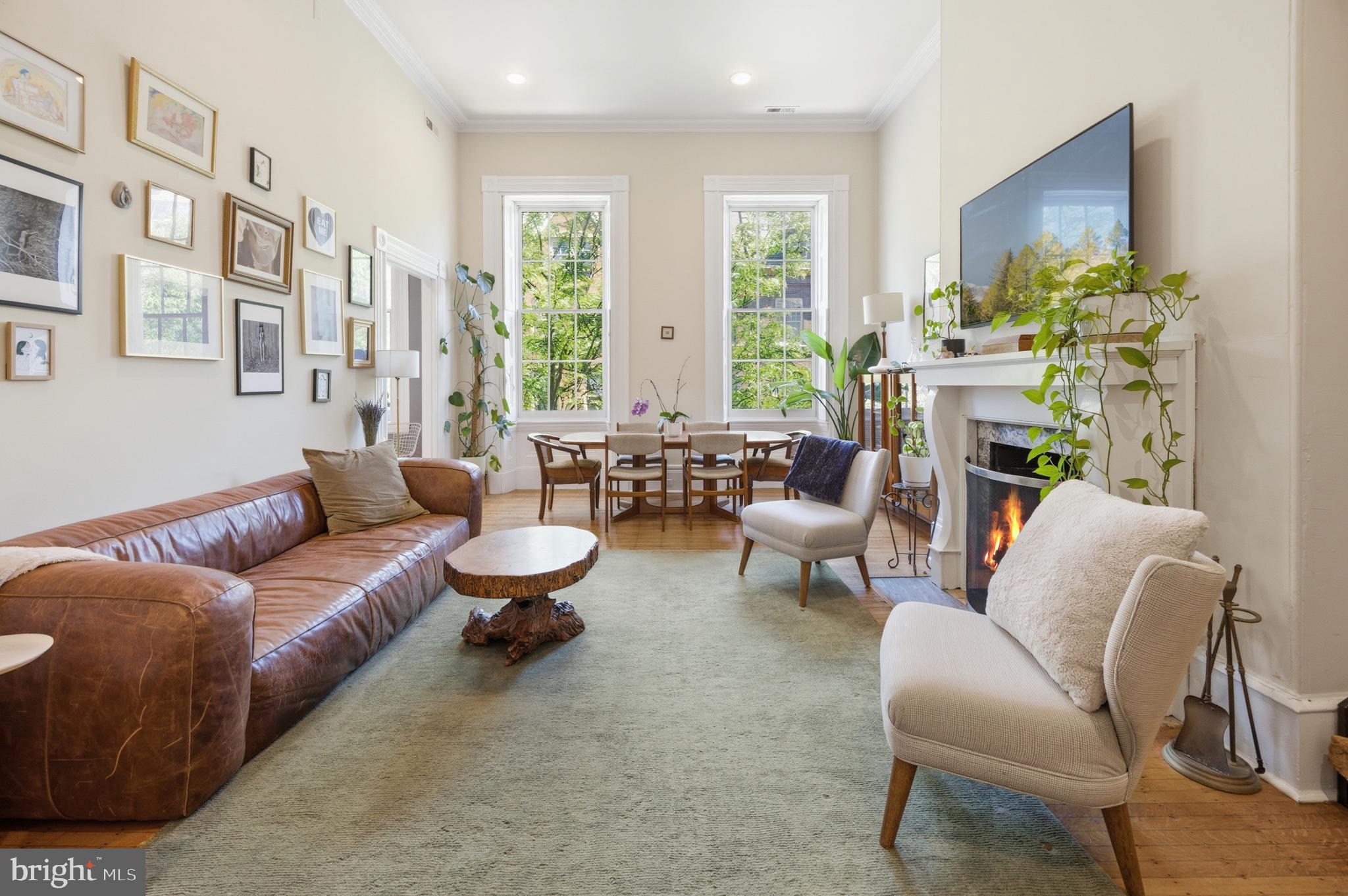 Welcome to 1108 Spruce Street, Unit 2F, a beautifully updated one-bedroom, one-bath condominium in the heart of Washington Square West. Occupying the full width of a boutique, historic building with views of leafy Spruce St, this light-filled residence blends timeless Philadelphia character with thoughtful, high-end modern upgrades.

Inside, you’ll find soaring 13-ft ceilings, oversized windows, original crown moulding, gleaming hardwood floors, restored self-storing shutters, and original wood-burning fireplace that showcases the home’s historic charm. The living room offers generous space for both living and dining, while the spacious bedroom features custom built-ins, an original marble fireplace surround, and plenty of room for a home office or sitting area.

The kitchen has been elevated with a custom-fit ZLINE built-in two-door refrigerator with an internal ice and water dispenser, a stainless steel induction range, a new stainless steel faucet, updated cabinet hardware and a brand new water heater. Additional upgrades include a new HVAC compressor and condenser, a new solid wood bathroom door to match the home’s original wood doors, and a fully re-caulked and waterproofed shower.

Historic details have been carefully preserved as well. The original shutters and hardware have been professionally restored and repainted, while the wood-burning fireplace and chimney have been restored, cleaned, and fireproofed, making the fireplace fully functional and ready to enjoy on cozy winter evenings.

Beyond the unit itself, the condominium has recently completed a special assessment for a new roof, and the rear brick staircase has been completely rebuilt, providing valuable peace of mind for the next owner.

Perfectly positioned on one of Philadelphia’s most picturesque tree-lined blocks, you’re just steps from Washington Square, the Avenue of the Arts, Antique Row, and neighborhood favorites including Habitat Coffee House, Static!, Known Associates, Kanella, Mixto, Mercato, and countless shops, restaurants, and cultural destinations. With easy access to Center City, public transportation, and some of Philadelphia’s most iconic landmarks, this exceptional residence offers the perfect combination of historic elegance, modern comfort, and an unbeatable location. A dedicated, gated parking space on the property is available for $235/mo.