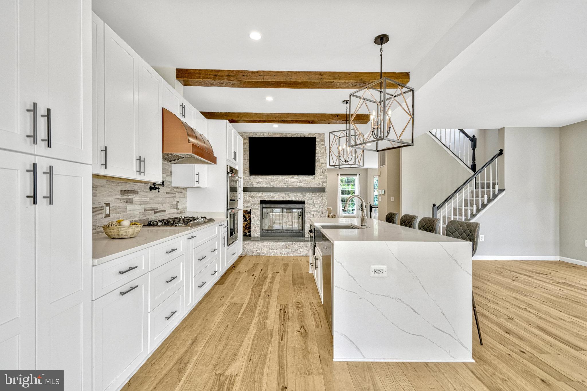 Welcome to your dream home! This exquisite end-unit townhouse, with three bedrooms, 3.5 baths, and just shy of 3,000 square feet of luxurious living space, is a true gem. Elegantly renovated with over 200k in renovations to provide modern comfort and style, this home is nestled in a family-friendly neighborhood and bathed in natural light. Owner is Carpenter and Agent and customized this home like none other!

Every detail has been meticulously crafted, from the modern appliances and fresh carpeting to the elegant flooring throughout. Each wall has been freshly painted, creating a pristine and inviting atmosphere.

The expansive, open-concept kitchen is a chef’s delight, featuring a magnificent waterfall island, state-of-the-art stainless steel appliances, a modern drawer microwave, and a dual oven. A built-in office desk offers convenience for managing daily tasks or working from home. Adjacent to the kitchen is a spacious dining room, perfect for hosting elegant gatherings. The kitchen seamlessly opens onto a sizable deck, ideal for alfresco dining and relaxation.

The living room exudes warmth and charm with its cozy wood-burning fireplace, which also adds ambiance to the kitchen area.

Upstairs, you’ll find three generously sized bedrooms. The primary bedroom is a true sanctuary, featuring a newly remodeled bathroom and the unique luxury of a soaking tub right in the bedroom—perfect for unwinding in ultimate comfort. An additional full bathroom on the upper level and a convenient half bathroom on the main level ensure ample space and privacy for all.

The finished basement is a versatile space, offering another full bathroom, a cozy gas fireplace, a comfortable living area, and a sun-filled den—ideal for a home office, playroom, or additional relaxation space.

A two-car garage provides ample space for parking and storage.

Lovingly renovated with attention to every detail, this home is ready for you to move in and start creating lasting memories. Your family will fall in love with this beautiful, light-filled townhouse. Don’t miss the opportunity to make this exceptional property your new home!
