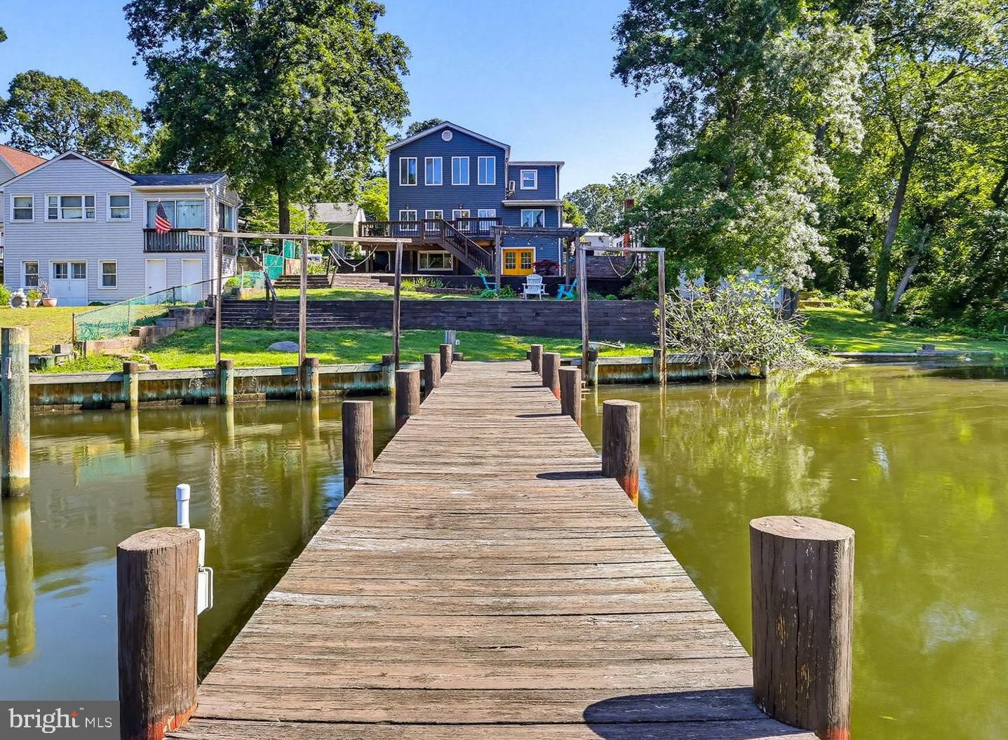 Your waterfront home awaits in sought-after Chelsea Beach on the Magothy River! Enjoy panoramic views from your tiered flat yard only a few steps above the water's edge. You'll find bedrooms with a direct water view on both levels along with lots of upgrades and custom features. The full unfinished basement is perfect for storage and a workshop. Relaxing or entertaining will be easy with the fabulous deck, fire pit and patio. In addition to your private dock, the community boat ramp is only a few hundred yards away on your side of the creek. Community will be easy with quick access to Rt. 100 (no Mountain Road gridlock). Don't miss this terrific opportunity. Contact us or your agent for a private tour!
