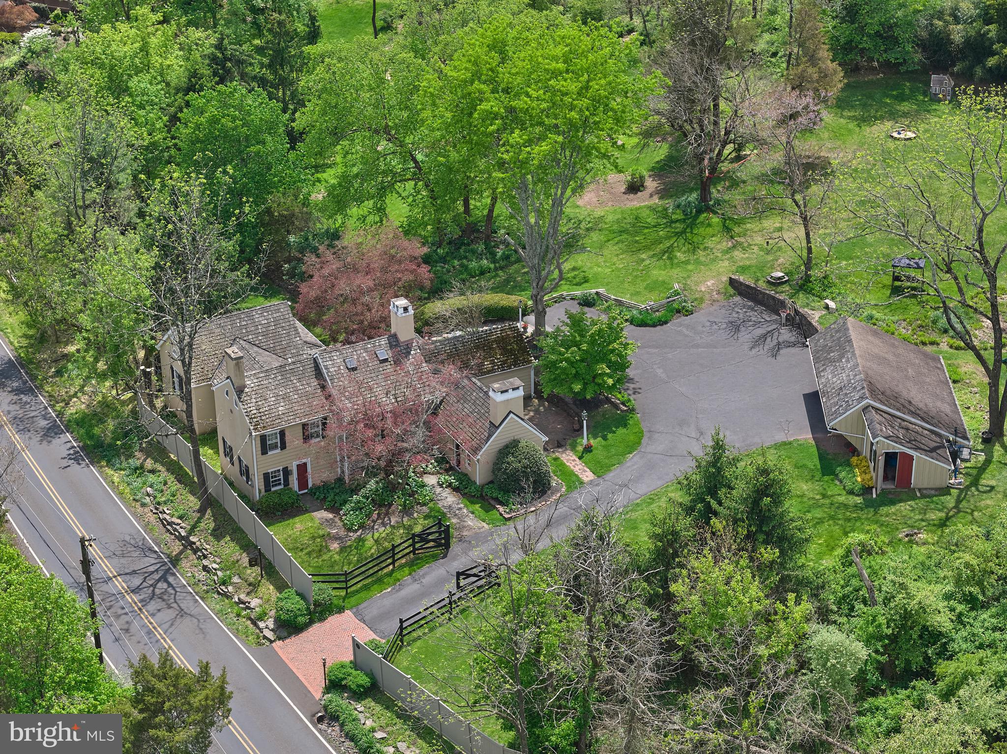 Arriving at Sunset Farm, a storied property whose roots stretch back through generations, you immediately feel the warmth and enduring character that define this exceptional home. Its exposed beams, stone walls, and time‑honored craftsmanship speak to a rich past, setting a timeless tone as you move from room to room. Two comfortable living rooms offer flexible spaces for gathering, relaxing, or entertaining, each thoughtfully designed to highlight the home’s inviting atmosphere. The kitchen is both functional and refined, featuring Miele appliances and an easy flow into the living and dining areas, making everyday living feel effortless. Just off the kitchen is a conveniently located half bath and a well‑organized laundry room, thoughtfully positioned for everyday practicality without interrupting the home’s aesthetic flow.

The tucked-away bedrooms of Sunset Farm continue this sense of calm, history, and care. Of the four bedrooms, two are spacious primary suites. One suite features its own bathroom complete with a skylight, and a dedicated dressing room, creating a quiet retreat. The second suite offers ample closet space and a large bathroom with a tub‑shower combination. Among the additional bedrooms, one includes a charming fireplace and direct access to a finished attic space—ideal for a studio, playroom, or office. 

The grounds of Sunset Farm reflect the same heritage and thoughtful stewardship. The home sits on a generous lot with mature landscaping that has been nurtured over time, enhancing both beauty and privacy. A secluded patio provides a peaceful place to unwind, dine outdoors, or entertain, all while surrounded by the natural setting that has defined the property for decades.

Set in a quiet, natural setting yet just minutes from the heart of New Hope, Sunset Farm offers a rare combination of charm, thoughtful updates, and an exceptional location.