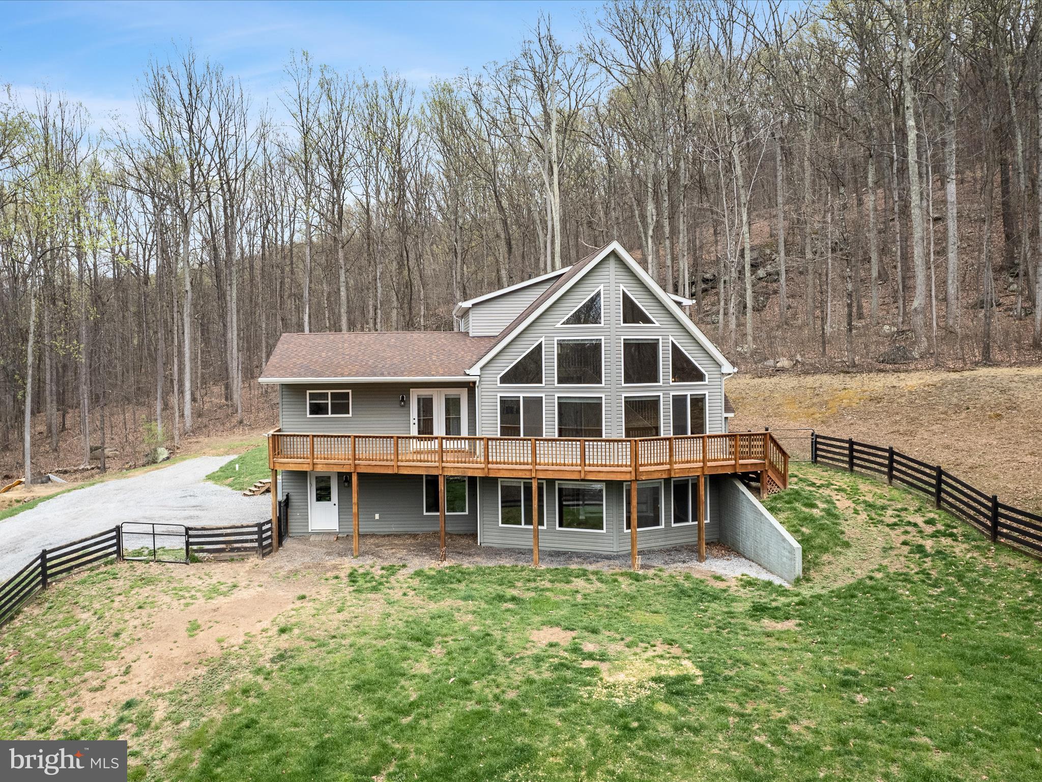 *NO DRIVE-BYS - PLEASE SCHEDULE AN APPOINTMENT OR VISIT THE OPEN HOUSE* Gorgeous A-frame chalet on a 4+ acre lot with wooded views and no HOA! This little community of only 3 well-maintained homes backs to the Appalachian Trail and is the ideal spot for a personal farmette while still being easily accessible to Northern Virginia. This remarkable rural homestead built in 2014 has 3 bedrooms and 3 full bathrooms arranged in nearly 2,700 square feet. The open concept main level features full-height windows, vaulted ceilings, a gas fireplace, and beautifully refinished hardwood floors throughout.  Gas cooking and a timeless custom backsplash enhance the appeal and functionality of the kitchen that features a generous island, large built-in pantry, and adjacent dining area. Two bedrooms and a full bath are located on the main floor, while the primary suite is privately situated upstairs. The walk-in closet has custom built-ins and an ensuite bath with tile shower and dual sinks. Downstairs on the lower level, a spacious recreation area provides the space for an extra family room, game area, or workout space. There's also an office, another full bath, and built-in storage for added convenience when coming in from the 2-car attached garage.  Wraparound decking, wood fencing and 10 ft high wire mesh fencing, a chicken coop, a separate shed, a shooting range, and a kids play set enhance the setting of this secluded, wooded oasis that's well-eqipped for gardening, animals, and outdoor fun. Updated with fresh paint and brand new garage doors, this quality custom home is a rare find and one you won't want to miss!