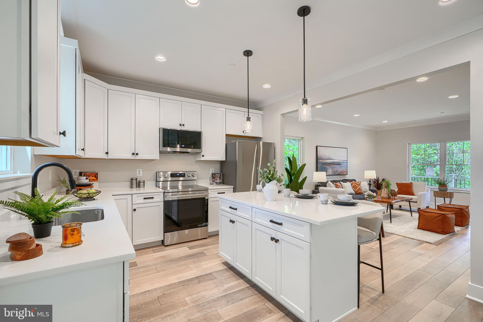 Welcome to 21 Jackson Avenue—a move-in ready new construction home tucked away on a quiet dead-end street and backing to a wooded conservation area. This thoughtfully designed home offers over 2,300 finished square feet across three levels, featuring 4 bedrooms, 3.5 baths, and an open-concept main living area filled with natural light. The fully finished lower level includes a spacious family room, wet bar, full bath, and additional bedroom, providing ideal space for guests, entertaining, or multi-generational living. Enjoy the rare combination of new construction, privacy, and convenience with easy access to shopping, dining, BWI Airport, Fort Meade, Baltimore, and Annapolis. No HOA and move-in ready.