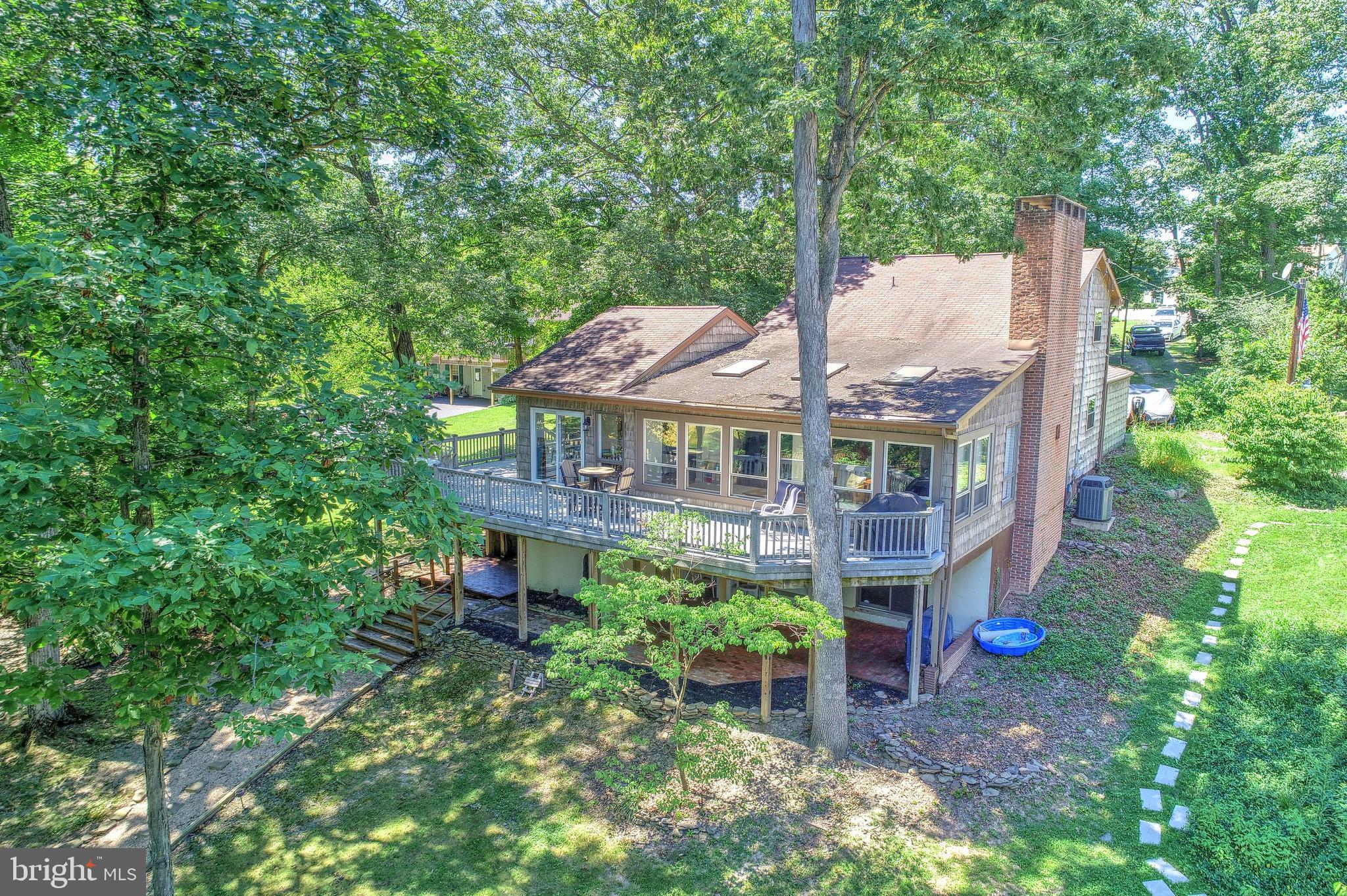 Experience the serenity of Lake Front living in this fantastic home in Lake Meade. The great room has beautiful hardwood flooring, a fireplace and is a generous size to entertain family and friends. The sunroom is bright and cheery with skylights and lots of natural light. The kitchen has a huge pantry, a sweet breakfast nook and all the appliances convey. The kitchen area is adjacent to an incredibly huge wraparound deck to enjoy the lovely lake views and the peacefulness you will find as you overlook the water.  When you re coming off a day of boating, fishing or swimming off your own dock, you will appreciate the convenience of walking into the lower level with a full bath and a family room. The family room boasts a wet bar and a fireplace, and has plenty of room for a pool table to continue the lake living fun. Outside living awaits you on this generous size lot that offers shade, or all the sun you want, lake side with very own dock. Swim, fish, kayak or hop in your boat and go enjoy wake boarding, water sports or a sunset cruise around the Lake. You will not lack areas for storage with a large storage room in the lower level, a tackle room and an over sized two garage. Beautiful sunsets and Serenity are waiting for you in this Lake front home in Lake Meade. Come enjoy the lifestyle of lake living today!Our Lake is manmade consisting of 300 acres and 5.84 miles of shoreline. Power boats, kayaks, canoes, sailboats and pontoon boats share the Lake. (Some restrictions apply) The Lake offers fun from tubing, water sports, and fishing. We are a private community gated community. Our gate is staffed 24 hours each day. Visitors and guest must register. The recreations activities include the swimming pool with lifeguards and a giant slide with two curves, zero entry with a mushroom fountain depth to 3 feet. Diving is 12 feet deep with two diving boards. Main rectangular pool is 50 x 82 with depths of 4 to 5 feet deep. There is also a bath house and a snack shack. Lake Meade has 10 water front access with boat docks, playground equipment and picnic places. There are 2 basketball courts and a tennis court. The sports complex offers ball field, sand volley ball courts, soccer fields, playground equipment for small children and a picnic pavilion. The marina complex features Macs pizzeria an informal eatery with outdoor deck and summer fun. There are two boat launches, limited boat services available. Our 4th of July celebration is culminated spectacular over the water firework display. Lake Meade Fire and Rescue is conveniently located in our community. Lake Meade Municipality provides public water and sewer.