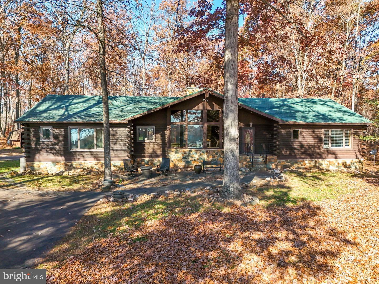 *PROFESSIONAL PHOTOS COMING SOON* Tucked away at the end of a long, tree-lined paved driveway, this breathtaking log cabin retreat is one of Nokesville's best-kept secrets on 3.5 acres. Nestled among mature hardwoods on a private, peaceful setting, this home offers the perfect blend of rustic charm, modern updates, and everyday convenience.

From the moment you arrive, you'll feel a world away from the hustle and bustle, surrounded by nature, beautiful wooded views, and the serenity that makes this property so special. Whether you're enjoying your morning coffee on the porch, gathering around the outdoor fire pit with family and friends, or simply taking in the peaceful surroundings, every inch of this property invites you to slow down and enjoy the beauty of country living.

Inside, you'll immediately be captivated by the soaring ceilings and the stunning floor-to-ceiling natural stone fireplace that anchors the main living area, creating a warm and inviting space that's perfect for cozy evenings or entertaining guests. The timeless character of this true log home is complemented by thoughtful modern updates throughout. The kitchen was beautifully updated in 2021, while the main-level bathroom was renovated in 2023. Additional improvements include a new HVAC system (2025), newer metal roof, updated windows, newer hot water heater, and 6-inch gutters providing comfort, efficiency, and peace of mind for years to come.

The finished walk out lower level offers exceptional versatility with a spacious flex room and kitchenette, making it ideal for multi-generational living, extended family, or long-term guests. You'll also find a dedicated recording studio, creating the perfect space for musicians, podcasters, content creators, or anyone looking for a private, sound-conscious workspace.

Although this property feels like your own private mountain retreat, you're just minutes from shopping, dining, and everyday conveniences, with quick access to Route 234 and Route 28, making commuting throughout Northern Virginia surprisingly convenient.

If you've been dreaming of a home that offers unmatched privacy, timeless character, modern updates, and a lifestyle unlike anything else on the market, this is your opportunity. Welcome to 10904 Manley Road, a rare retreat where peaceful living meets everyday convenience. Nokesville's best-kept secret is ready to welcome its next owners home.