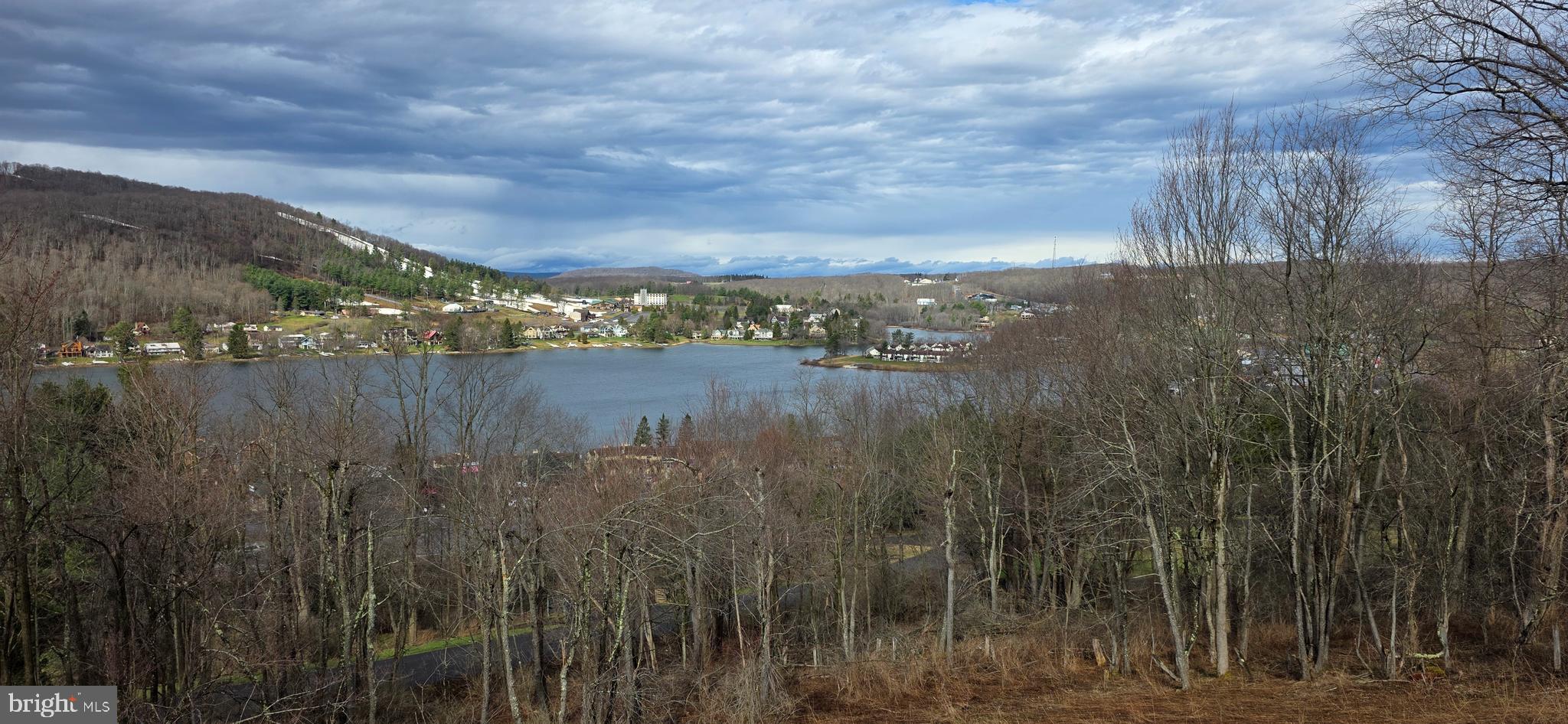 ELITE ski slope and water views at Timber Ridge! Spectacular location in the heart of McHenry - directly across the street from Fun Zone / Black Bear / Pine Lodge Steakhouse. This wooded building lot offers a FANTASTIC location with potential for wide,  postcard views of Deep Creek Lake and Wisp Ski Resort. Approved for a 3BR septic. Reach out for more details about building details, simple architectural review guidelines and more details about the community. *Several photos displayed were taken slightly above lot 10 to show potential slope/water views from approx. height of a new home; views will vary based on house location, placement, design, etc.