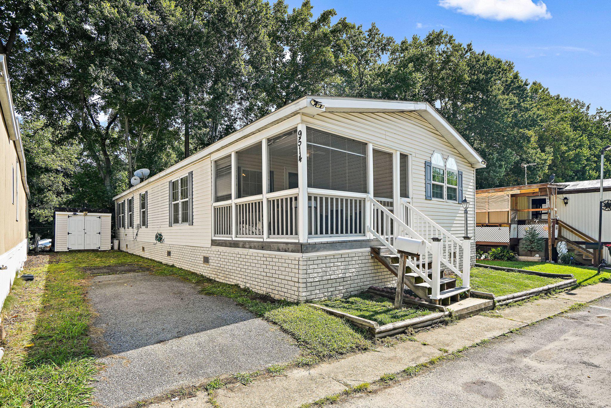 Discover the charm of this delightful double-wide manufactured home nestled in the serene Fernwood Mobile Home Park. Built in 2007, this well-maintained residence offers a perfect blend of comfort and functionality, making it an ideal retreat. A spacious screened in porch with lots of natural light provides the ideal space for morning coffee or afternoon tea time. Step inside to find a warm and inviting interior featuring three spacious bedrooms and two full bathrooms, including a soaking tub for those relaxing evenings. The combination dining and living area creates a cozy atmosphere, perfect for gatherings or quiet nights in. The kitchen, equipped with a built-in microwave, dishwasher, and refrigerator, boasts ample table space for casual dining. Enjoy the convenience of main-floor laundry with both a washer and dryer included, making chores a breeze. The home also features walk-in closets, providing plenty of storage for your belongings. Outside, the paved driveway offers easy access and assigned parking for your convenience. The community is surrounded by lush greenery, providing a peaceful environment to unwind. Located in a vibrant neighborhood minutes to I495, residents can enjoy nearby parks, shopping, and dining options, enhancing the overall living experience. This home is not just a place to live; it's a place to create lasting memories. Embrace the comfort and community of Fernwood Mobile Home Park today!