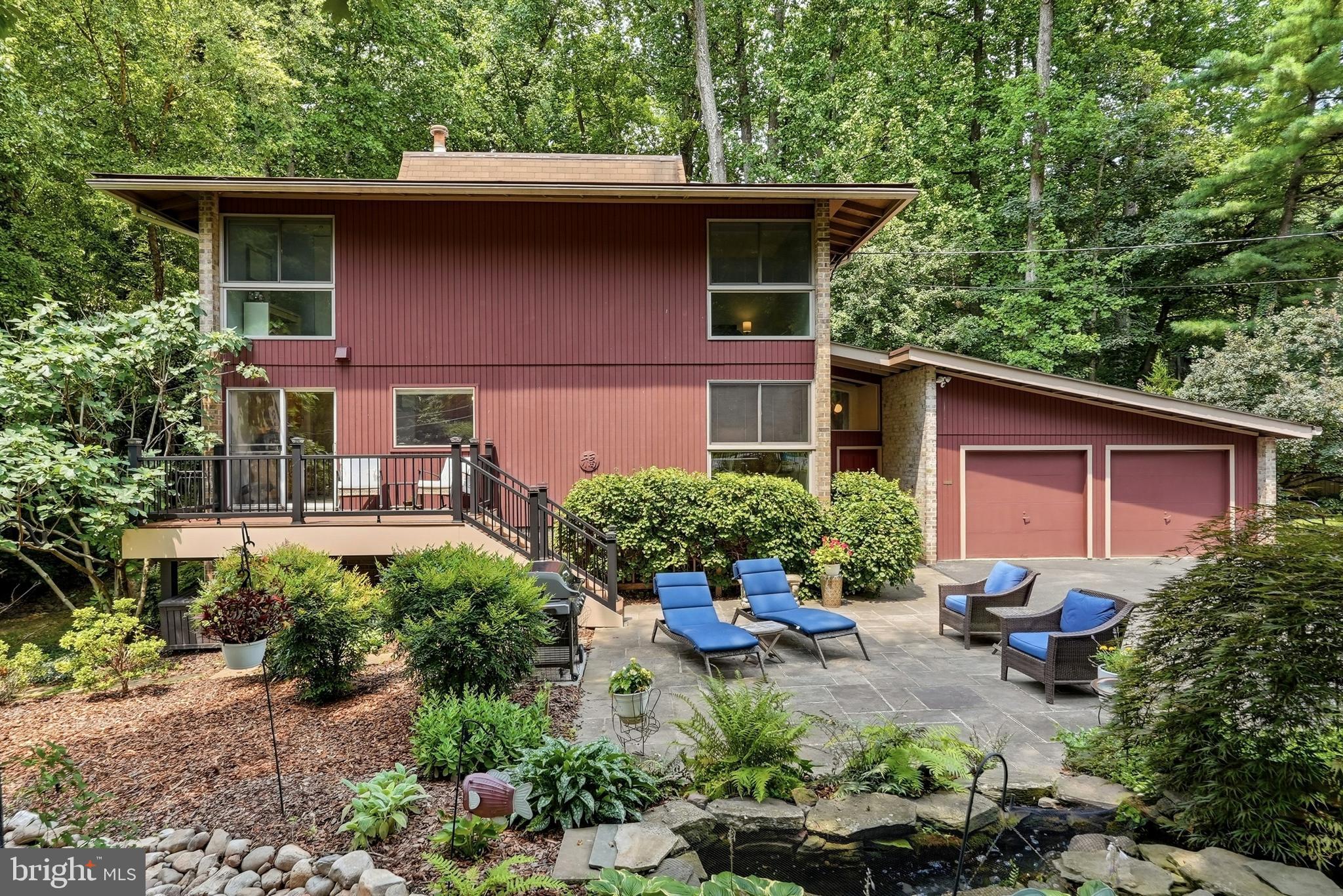 Mid-Century Modern Retreat on a Private Wooded Lot! Brand New will be said a lot when touring this home!

Set on an expansive 18,000+ square foot wooded lot, this beautifully renovated mid-century modern home blends timeless architecture with modern luxury and exceptional privacy. Offering approximately 3,000 square feet of living space, this home features 5 bedrooms, 3 full bathrooms, and 1 half bathroom, along with a two-car garage. The fully fenced property includes custom black aluminum fencing, an automatic driveway gate, and a separate pedestrian entrance.

Over $100,000 has been put into this home since it's last sale! Inside, fresh paint, new lower-level flooring, and designer lighting create bright, welcoming living spaces. The stunning kitchen is the heart of the home, showcasing a 10-foot Blue Roma quartzite waterfall island, GE Café Series appliances, a dedicated coffee station, custom bar, and built-in wine refrigerator—perfect for everyday living and entertaining. 

The home offers three full bathrooms and one half bathroom, all stylishly updated with clean, contemporary finishes. Step outside to enjoy a new composite deck with integrated step lighting and solar accents, creating an ideal space to relax or host guests. The front brand new composite deck provides the perfect spot to enjoy your morning coffee while taking in the peaceful surroundings.

Additional upgrades include a new electrical panel, BMW EV fast charger, new water heater, and brand-new washer and dryer, making this home truly move-in ready in a serene setting with convenient commuter access.

A lot of NEW in this description.