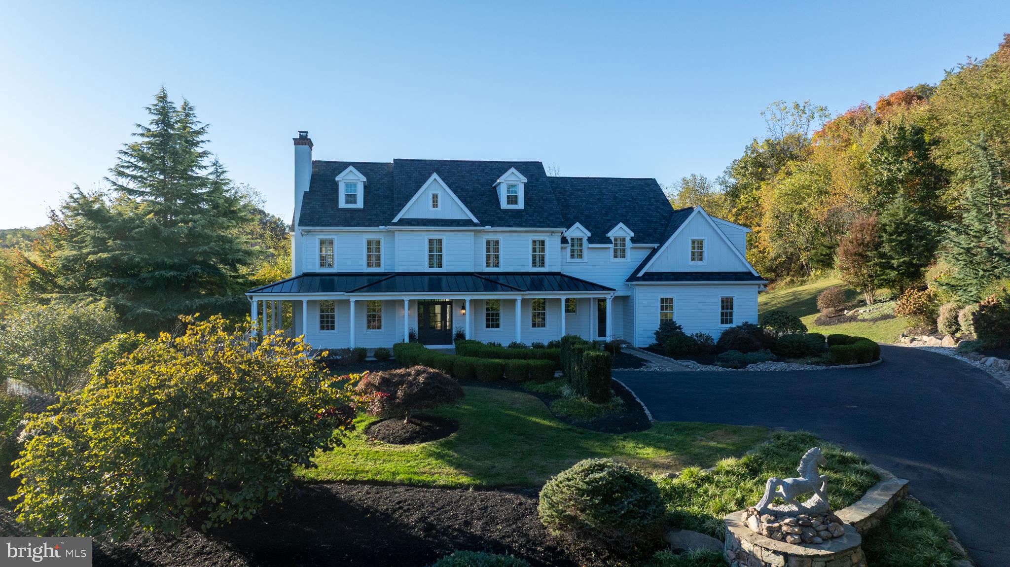 Set back on a tree-lined driveway amid 4 peaceful acres, this stunning 4,764-square-foot Chester Springs estate blends timeless architecture with modern comfort and thoughtful upgrades throughout.

A grand entrance welcomes you into an open, light-filled home that radiates warmth, charm, and sophistication. The inviting wraparound porch, overlooking a tranquil water garden and Koi pond, sets the tone for a lifestyle of serenity and connection—perfect for morning coffee, evening sunsets, or quiet reflection surrounded by nature.

Inside, you’ll find five spacious bedrooms and four full plus two half bathrooms, including a luxurious master suite with his-and-her closets and spa-inspired finishes. The brand-new designer kitchen shines with custom cabinetry, premium countertops, and high-end appliances—beautifully designed for both daily living and entertaining.

The main level also features a library/home office, offering an ideal space for reading, working, or study. From the adjoining living area, step through French doors onto a private outdoor patio, perfect for gatherings or peaceful evenings outdoors.

The finished basement includes a wet bar and generous open space for recreation, fitness, or guest accommodations—ready to adapt to your lifestyle.

Outside, enjoy a beautiful pool and patio area, framed by mature landscaping and complete with connections for a pool heater. The wrought-iron garden pavilion provides a storybook setting for relaxing, reading, or simply enjoying the serenity of your surroundings.

Additional highlights include a comprehensive security system with automatic fire alarm, a brand-new roof with a 50-year limited warranty, brand-new siding, and a three-car garage.

There are simply too many details to mention—this extraordinary property must be seen to be fully appreciated.