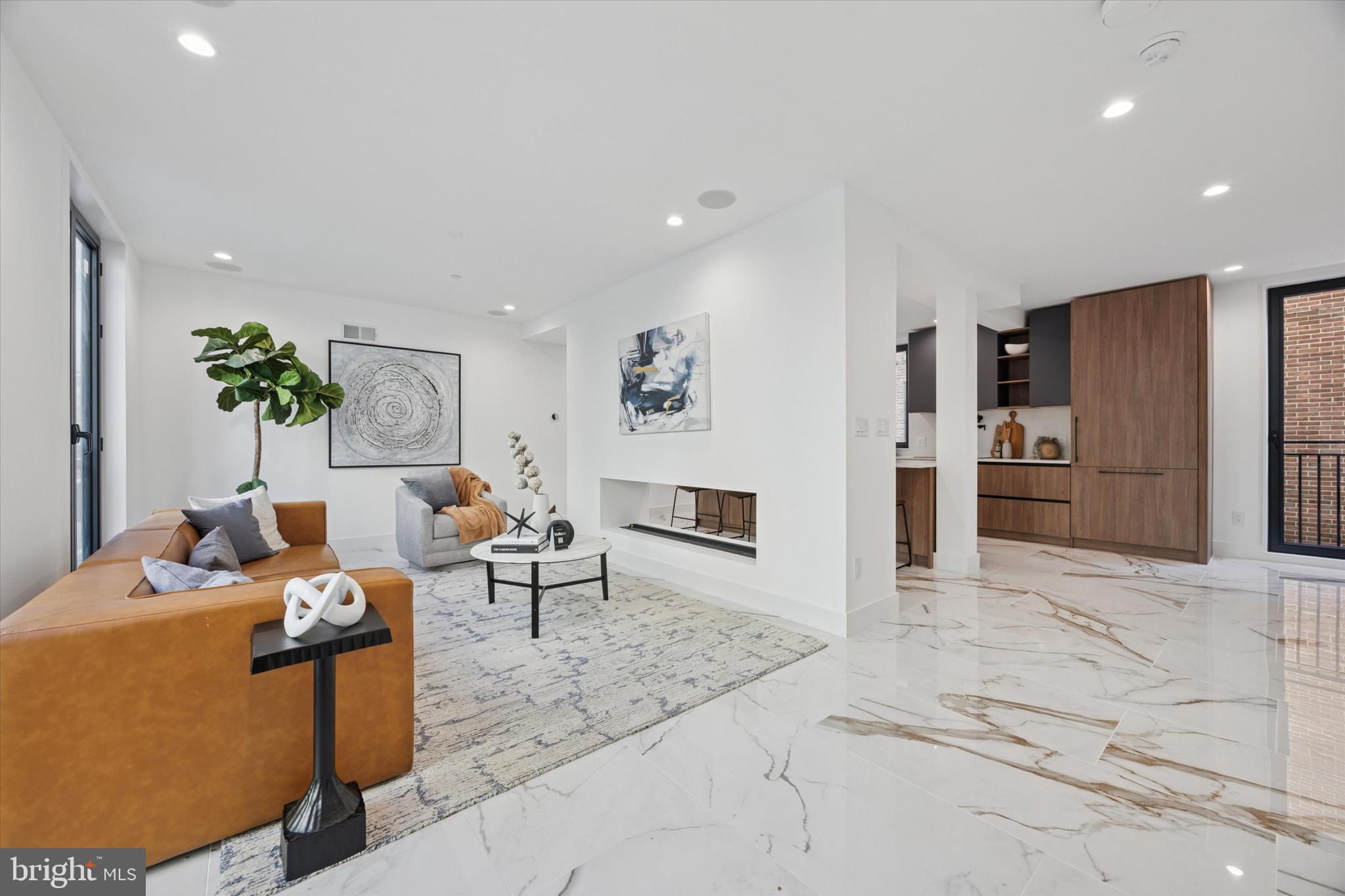 Introducing Parkside South, Philadelphia’s premier gated enclave of contemporary luxury townhomes in Packer Park. Experience refined city living in this private community featuring a collection of 4- and 5-bedroom residences with two-car garages, 5 stop elevators, expansive rooftop decks, and approved tax abatements. Parkside South combines modern architecture, sophisticated design, and everyday comfort into one seamless lifestyle. Each home showcases an open-concept floor plan drenched in natural light through imported Italian floor-to-ceiling windows. Sleek Italian tile flows throughout, setting the tone for a clean, elegant aesthetic. This fully upgraded ultra wide unit offers 5 bedrooms and 4.5 bathrooms, designed with every detail in mind, from thoughtful layout to premium finishes. The chef’s kitchen is a true showpiece, featuring cabinet-integrated appliances, a built-in wine refrigerator, an oversized central island for entertaining, and a spacious walk-in pantry. Upstairs, the primary suite serves as a private sanctuary with a spa-like bath that includes a soaking tub, rainfall shower, and radiant heated floors. The rooftop deck elevates your living experience,  a stunning space to host guests or unwind while taking in the views of Philadelphia’s skyline, bridges, and sports arenas. Parkside South homes are equipped with smart home automation, allowing effortless control of dual-zone HVAC, lighting, surround sound, and garage systems directly from your phone or tablet. Designed for both comfort and convenience, each home includes secure gated access, private parking, and proximity to major highways, public transit, and the city’s top cultural attractions. Don't miss out on this opportunity to make Parkside South your home, reach out today!