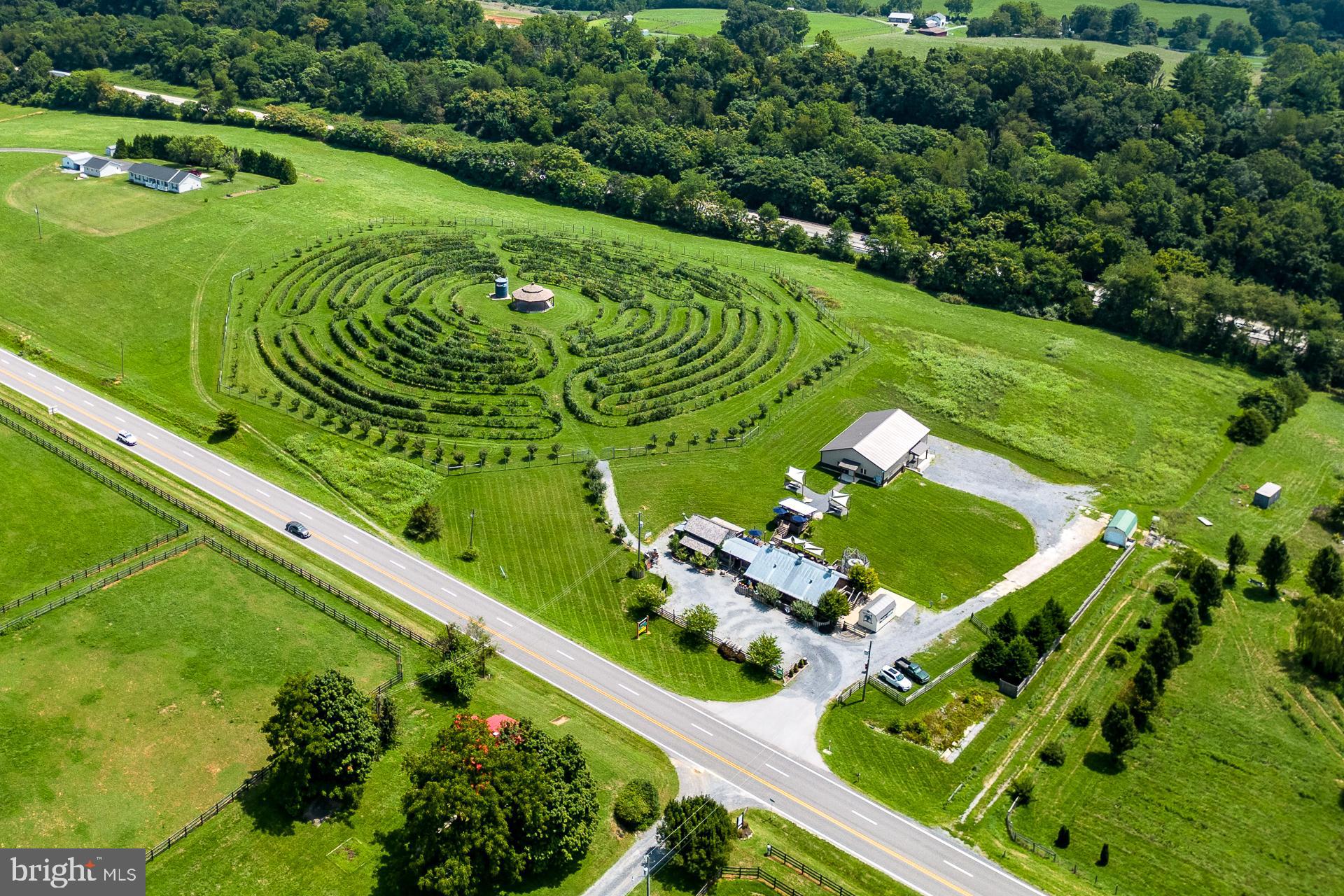 Welcome to your slice of paradise in beautiful Shenandoah Valley. Halcyon Days Cider Co. & Labyrinth Orchard is a turnkey, boutique farm Cidery on 11.08 acres (2 parcels total). Established in 2018, Halcyon Days was the first Cidery to open in Rockbridge County. Surrounded by sweeping blue skies and stunning mountain vistas, the Cidery is ideally situated in Natural Bridge, VA and enjoys a steady stream of local and visitor traffic from the major Rt. 11 and I-81 corridors. 

Blending deep respect for traditional methods with newly refined techniques, Halcyon Days produces about 20 different delicious, quality dry and sweet hard ciders annually. By allowing the 100% Virginia-grown apples, including many heirloom varieties, to speak for themselves, Halcyon Days’ ciders reflect true vibrancy and taste.

The Cidery property contains multiple buildings and spaces, making for flexible, all-season uses. The owners painstakingly rescued an 1860s log cabin from nearby North Mountain and restored it to its former glory log by log to become the quaint-as-can-be Tasting Room. From the ample open and shaded outdoor seating to the adjacent game room and private event space to the Orchard Labyrinth and Event Pavilion, the Cidery is fully operational and optimally primed for the next owner to expand and grow the operations.

You'll marvel at the large, almost-new Production Building built in 2022 and carefully designed by the owner with harvesting, processing, and bottling activities at the forefront. State-of-the-art equipment—all of which conveys to the new owner—includes 18 unjacketed, stainless steel, 120-300 gallon tanks; hand-bottling machine, bladder press, small hydraulic press, work tables, pumps, filters, grinder, and carbonator. Production is even large enough to incorporate wine barrels, tanks, and some winemaking equipment, should the purchaser wish to explore winemaking activities onsite. The Cidery operates under a Virginia Farm Winery license. 

The one-of-a-kind Orchard Labyrinth located at the Cidery is a well-known attraction in Rockbridge County. An amazing feat, the design is modeled on the labyrinth of Our Lady of Chartres Cathedral in France. In this adaptation, the trees are pruned and trained along a trellis system to create the “walls” of the labyrinth. Planted in 2016, the Labyrinth is 4.45 acres and contains nearly 1,900 dwarf apple trees of 50 varieties. The orchards have an average annual production capacity of  800-850 bushels.

***Full marketing brochure available to qualified buyers. The offer price is inclusive of the real property, cider inventory, FF&E, and goodwill. The property is in land use. Seller is not responsible for rollback taxes. Assessed value listed is for 11.08 total acre parcels only.***

***The Listing Price change on 2/20/25 reflects the sellers' decision to remove two parcels (Tax ID #96-19-10 at 18.11 acres and Tax ID #96-19-2 at 7.35 acres)  from the overall offering. These parcels may be made available for sale with a right of first refusal for this listing's buyer. The parcels contain approximately 5 acres of orchards, which will also be available to lease for the future buyer.***

Adjacent to the off-site orchards, there are two additional parcels (10 acres total) available under separate purchase with a different seller.