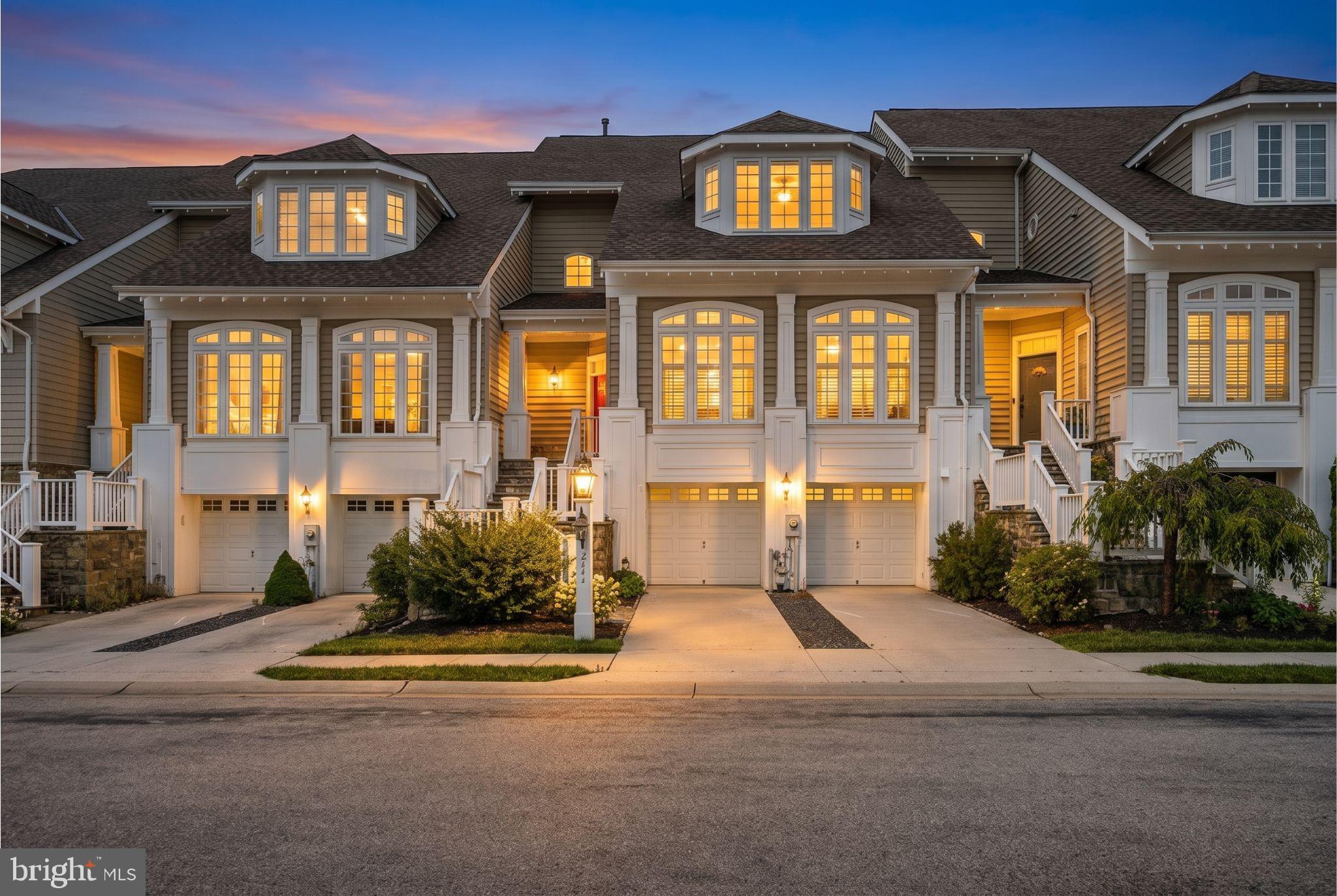 Prepare to be captivated by this exceptional luxury townhome offering over 2,865 square feet of impeccably appointed living space with breathtaking lake views in Howard County's premier gated community, Stone Lake. This elegant residence features 3 bedrooms, 3 full baths, 1 half bath, and a spacious 2-car attached garage, all complemented by resort-style waterfront amenities surrounding the beautiful 25-acre lake. Recent owner improvements including brand-new carpet in the primary suite (2026), fresh interior paint throughout approximately 75% of the home (2026), a new wall oven (2026), custom millwork, a custom fireplace mantel, custom window treatments, and a replaced HVAC system (2022). Step inside to discover gleaming hardwood floors, exquisite wainscoting, chair rail detailing, crown molding, and abundant natural light that fills the formal living room. The elegant dining room flows seamlessly into the open concept first floor, creating an ideal setting for both intimate gatherings and grand entertaining. Past the powder room, the expansive gourmet eat-in kitchen impresses with granite countertops, an oversized center island with breakfast bar seating, abundant cabinetry, a tile backsplash, stainless steel appliances, a generous pantry, and an inviting breakfast area. Sunlight pours through oversized windows, and the adjoining breakfast room provides access to the rear deck, where stunning lake views create the perfect backdrop for morning coffee or evening relaxation. Just beyond, the spacious family room is anchored by a gas fireplace with custom built-ins and is pre-wired for a 5.1 surround sound system. Oversized windows frame picturesque water views and flood the space with natural light. Retreat upstairs to the luxurious primary suite, which features a two-story vaulted tray ceiling, sitting area, two custom walk-in closets, and a private balcony with tranquil lake views. The spa-inspired ensuite offers separate vanities, an oversized dual-entry shower, and a soaking tub overlooking the water. A spacious second bedroom includes a walk-in closet and private ensuite bath, while the upper-level laundry room adds convenience. The finished walk-out lower level offers a spacious recreation room pre-wired for a 7.1 surround sound system w/speakers, a third bedroom, a full bath, and direct access to the stone patio. Backing to mature trees with captivating lake views, the outdoor living space offers a private setting for entertaining or unwinding. Residents of Stone Lake enjoy exclusive amenities including tennis courts, a putting green, playground, walking trails, lakeside pavilions, and so much more!