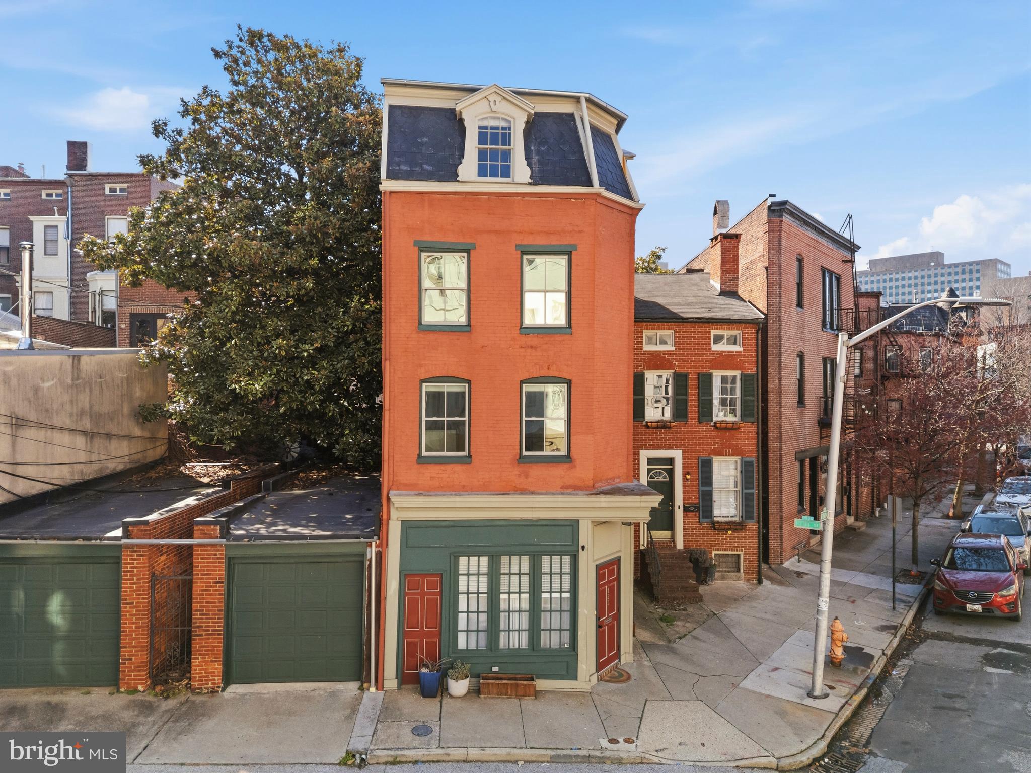 Welcome to this unique 4-story townhouse in the heart of one of Baltimore's most beloved neighborhoods. This distinctive home, crowned with a striking mansard roof, seamlessly blends over a century of history with thoughtful modern updates.

This 4-bedroom residence offers versatile living across four well-appointed floors. The first floor features an updated kitchen and dining area with basement access and convenient main-level laundry. The second floor provides a spacious living area, one bedroom, and a full bath, perfect for entertaining or just to spread out a little. Two additional bedrooms and a full bath occupy the third floor, while the fourth floor boasts a luxurious primary suite complete with a full bath. The 5th bedroom is also on this floor that the current owner uses as a dressing room, equipped with a separate closet with laundry hookup for extra convenience. 

Large windows means lots of natural light and access to the outdoors from the first, second, and third floors. The home's unique layout provides both privacy and connection, ideal for modern living.

Mt. Vernon doesn't get better than this. You're in close proximity to MICA, University of Baltimore School of Law, the Enoch Pratt Central Library, and the Baltimore Symphony Orchestra at the Meyerhoff. Great restaurants, boutique shops, and cultural institutions surround you, while I-83 access makes commuting effortless.

This home use to serve as a grocery store in the 1930s, followed by various restaurants and bars over the years and now shines as a wonderful private home.

Don't miss this rare opportunity to own a piece of Mt. Vernon history with all the comforts of contemporary living.