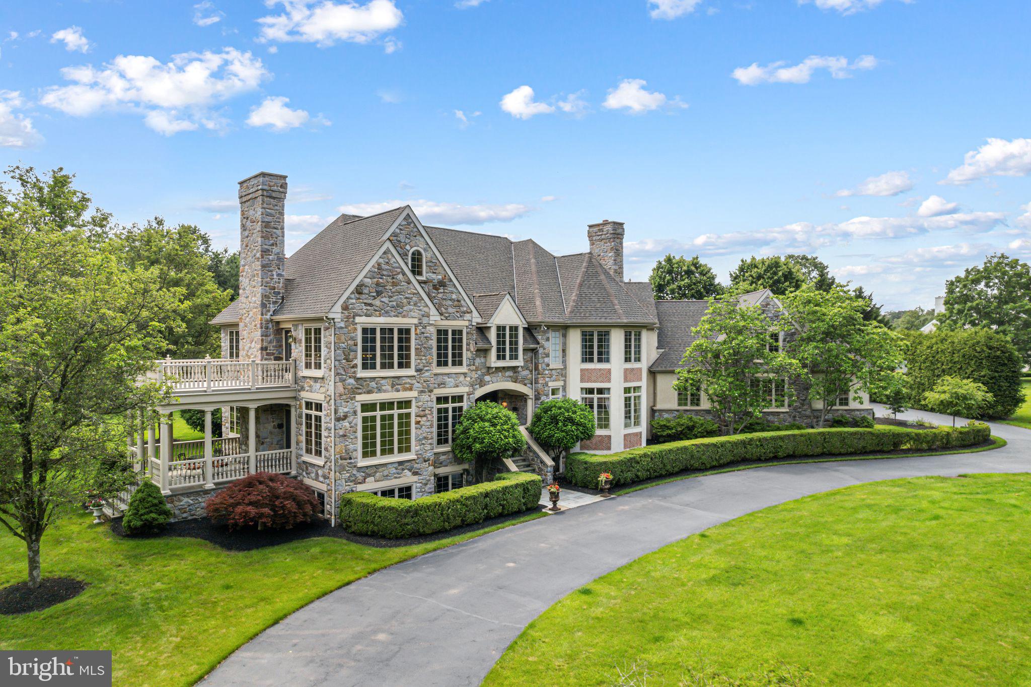 Welcome to your dream home! This exceptional Guidi custom-built estate, a luxurious 6-bedroom, 5.2-bath residence nestled on a stunning double lot spanning over 2 acres in one of Lower Gwynedd’s most coveted neighborhoods, Polo Club Estates. This extraordinary home exemplifies refined elegance, beginning with a professionally landscaped grand entrance, a circular driveway, new roof and a stately paver walkway leading to a covered front entry.
Inside, the marble foyer opens to a sweeping staircase and exquisite imported Murano doors from Italy, guiding you into a dramatic two-story living room. Rich millwork, a custom gas fireplace mantle, and floor-to-ceiling decorative moldings evoke timeless sophistication. Lower terrace with large columns and flagstone pavers off living room. Upstairs, a magnificent library adorned with custom built-ins and ambient lighting offers access to a private upper-level terrace.
A striking 125-gallon see-through freshwater aquarium stylishly separates the sunken family room—featuring recessed lighting, a wood-burning fireplace, and sliding doors to a screened-in slate porch. The gourmet kitchen is a chef’s dream, complete with tile floors, granite countertops, custom cabinetry, a spacious center island, dual dishwashers and ovens, a six-burner cooktop, and a built-in custom  refrigerator. The adjoining breakfast room, with its soaring ceiling and expansive windows, offers scenic views of the porch and gardens.
A butler’s pantry connects to the elegant formal dining room, graced with hardwood floors, intricate moldings, a marble gas fireplace, and an abundance of natural light from oversized windows. A recent renovation transformed the private home office, now featuring hardwood floors, recessed lighting, and double French doors. Additional main-level amenities include a full bath, a powder room with a pedestal sink, and a spacious laundry room with a built-in desk, all offering easy access to the attached three-car garage with custom built garage doors.
Upstairs, the expansive primary suite is a true retreat, with cathedral ceilings, generous windows, a cozy fireplace, and a custom walk-in closet. The luxurious en-suite bath includes dual vanities, a large, tiled shower, a Jacuzzi tub, and abundant natural light. Four additional upstairs bedrooms, each with plush carpeting and ample closets, enjoy the privacy of their own en-suite baths. A spacious sixth bedroom on the third-floor features high ceilings and generous storage.
The newly finished lower level is designed for entertaining, boasting high-end resilient flooring, a full bar with pendant lighting, high ceilings, space for a pool table, a cozy lounge area, and a stylish half bath. Behind the barn doors this expansive basement offers the ideal footprint for a custom golf simulator setup. With generous ceiling height, ample floor space, and minimal obstructions, it’s a dream space for golf enthusiasts seeking a private, year-round practice environment.
Outdoors, the expansive EP Henry patio, complete with stone walls and a full outdoor kitchen, sets the stage for unforgettable gatherings. A full basketball court and meticulously landscaped grounds complete this serene and elegant setting. 
Come experience the pinnacle of luxury living in the heart of Lower Gwynedd.