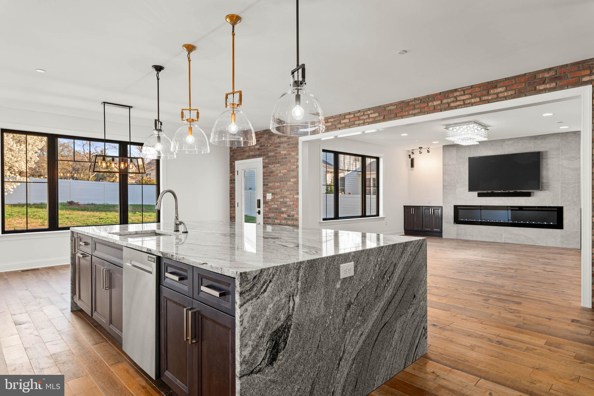 Step into this move-in ready residence offering the look and feel of new construction, all without the restrictions or fees of an HOA. This exceptional one-of-a-kind home showcases craftsmanship, thoughtful design, and uncompromising quality throughout. Personally designed and lightly lived in by an experienced designer-builder, every detail has been intentionally selected with finishes chosen for both beauty and performance. The exterior makes a lasting impression with timeless architecture, custom garage doors, stamped concrete, metal roofing accents, upgraded trim work, and a striking blend of reclaimed brick and stone. Expansive Andersen architectural windows with bold black framing create a dramatic yet welcoming presence while filling the interior with natural light. The fully enclosed backyard offers a private outdoor setting with a level, usable layout ideal for a future pool, outdoor kitchen, or custom hardscaping. White vinyl privacy and semi-privacy fencing create a secure environment, complemented by solar-powered accent lighting and custom aluminum gates. Inside, the light-filled layout features soaring ceilings, oversized windows, designer lighting, and a striking staircase with sleek metal cable railing. The chef-inspired kitchen offers custom cabinetry, premium granite waterfall countertops and backsplashes, designer lighting, custom hood, and top-of-the-line appliances. A butler’s area with a four-bottle wine pouring station adds convenience for entertaining. The open-concept design flows into the dining and living areas, highlighted by a dramatic 110-inch fireplace. The primary suite serves as a private retreat with tray ceilings, an expansive walk-in closet, and an all-season balcony overlooking the backyard, perfect for enjoying sunsets, winter snowfall, or fireworks. The spa-inspired bathroom features a double-seater Jacuzzi tub, dual vanities, dual showers, custom tilework, and a heated towel bar. The walk-in closet includes a premium Avera closet system.Additional highlights include oversized bedrooms, wide-plank hardwood flooring, upgraded millwork, and distinctive architectural details throughout. The powder room showcases a custom Philadelphia skyline penny tile mural. The second-floor laundry room features custom cabinetry, farmhouse sink, beverage cooler, and generous folding space. The partially finished basement provides approximately 1,800 square feet of additional space ready to be customized. Once completed, the home will offer approximately 5,200 square feet of refined living space. Built as a luxury model home with meticulous attention to detail, this property presents a rare opportunity to own a truly exceptional residence that must be experienced in person to be fully appreciated.