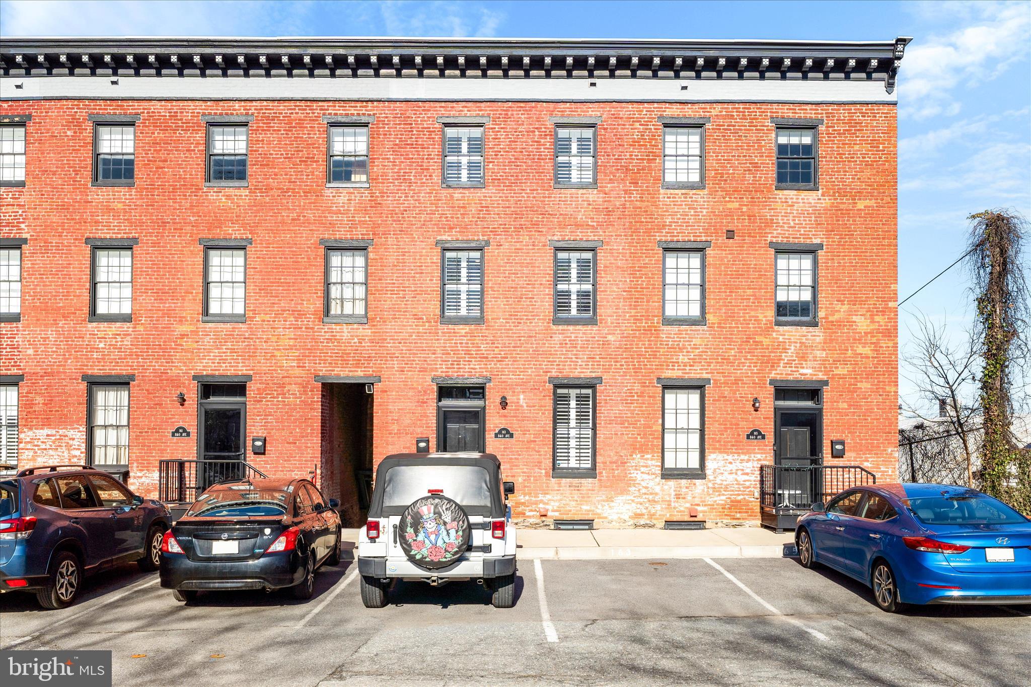 Welcome to this truly unique renovation in Downtown Frederick! This beautifully renovated 4-bedroom, 3-bath home blends modern living with historic charm, in one of the area’s most walkable and spotlighted locations. Just steps from Carroll Creek Linear Park, this row-home offers unbeatable access to dining, shopping, and local amenities. From the moment you enter, tasteful finishes and features, are on full display. Boasting a modern kitchen with ample cabinetry, a center island with bar height dining, exposed brick and bemas, stainless appliances (including a brand-new refrigerator), custom iron staircases with soaring 10-foot ceilings, and large refinished windows, provide abundant light throughout. The second level offers two private bedrooms, a conveniently located hall laundry area, and a shared bath complete with dual vanities, elegant lighting, and a beautiful tile shower/bath combo. The private upper level, provides a versatile loft-style space with an en-suite full bath and storage—ideal as a primary suite, guest retreat, or home office. The fully finished lower level includes  walkout access to the patio and yardspace, an additional full bath, ample storage, and flexible space for a bedroom, gym, or entertainment area. This is a rare opportunity to own a thoughtfully renovated home in Downtown Frederick, from a one-of-a-kind project completed in 2021. With close proximity to the MARC train, breweries, shops, dining, and major commuter routes, the location truly speaks for itself. Schedule a tour, now!