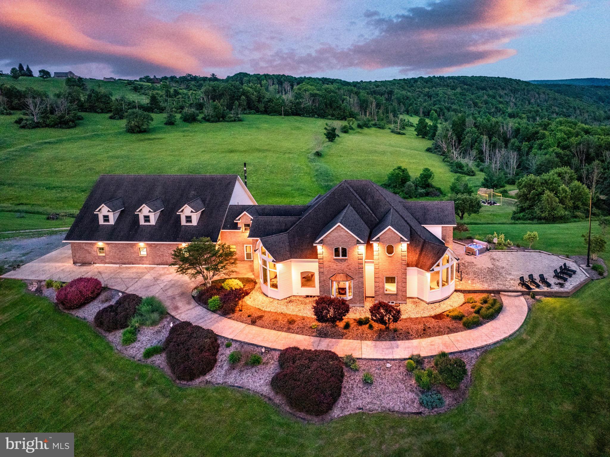 Discover an extraordinary lifestyle with this 11,762 sq ft estate on 50 +/- acres of lush land for your dream residence or an Airbnb investment. Admire breathtaking views from this stunning 5 bed 6 bath home blending luxury with nature. Through expansive windows enjoy panoramic scenery with the serene pond fields and woods that are enriched with abundant wildlife. The main level features a custom kitchen, grand master suite, laundry room, library, and office. The impressive living room with cherry hardwood floors leads to a sweeping staircase, and upstairs hosts two bedroom suites ensuring privacy. The daylight basement offers potential for in-law quarters or a rental apartment with its own kitchen and entrance. Enjoy the efficiency of radiant heating throughout, supplemented by a waste oil burner in the garage, ensuring economic warmth. The "6 car garage" accommodates a pickleball court and game room and is easily reconfigurable. Conveniently located near Tioga County attractions.