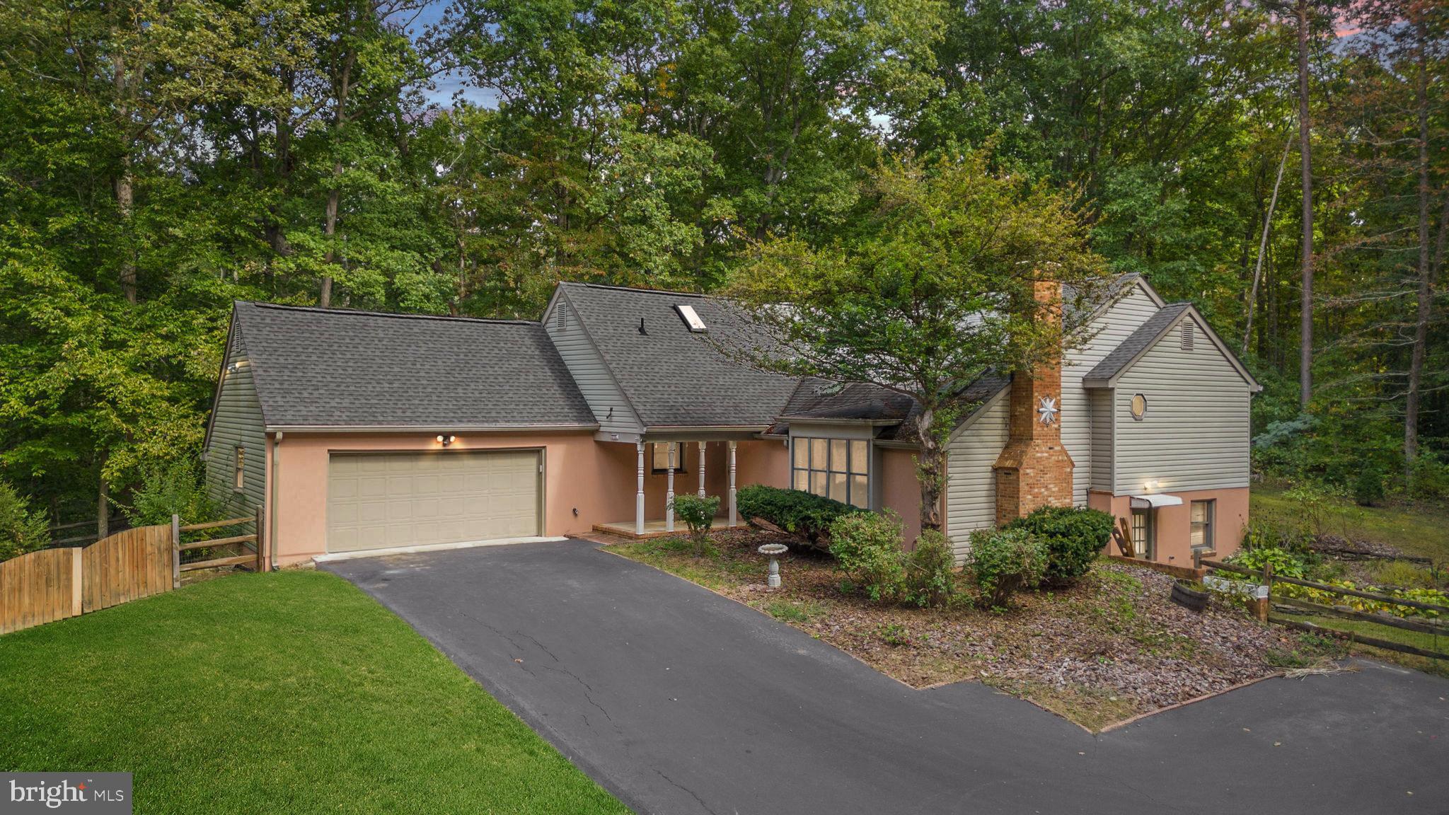 Welcome to your private oasis located in the tranquil neighborhood of Brookewood Estates.  This home sits on a private 2.43-acre lot and offers a relaxing front porch and backyard views.  Inside, you'll find a comfortable sunken family room with skylights, cathedral ceilings, built-in shelving w/ cabinets, and a wood-burning fireplace (wood stove insert).  The main level offers a generous-sized kitchen with a large center island and Corian countertops. Off the kitchen, there is a powder room and access to the oversized 2-car garage and huge 2-tier deck w/ fenced-in backyard! There's even a Screened Gazebo (w/ electricity and a ceiling fan) to enjoy a morning cup of coffee or an evening cocktail.  Inside is a separate Dining Room with tons of natural light from the large window that overlooks the deck.  Up a few stairs, you will find the 3 bedrooms and 2 full baths.  The primary features his and her closets and the ensuite has been tastefully updated with a comfort height double vanity, HEATED ceramic tile floors, and a spacious walk-in glass shower. The lower level is unfinished with room to add a 4th bedroom/flex area.  There is a second lot (19 A)/ 0.617 Acres) located across the street from the driveway that conveys with the sale and features almost 35' of waterfrontage on the community Sleep Hollow Pond!  Centrally located to VRE, Downtown, the Commuter Rail, and all your favorite shops and restaurants.  Schedule your showing today!