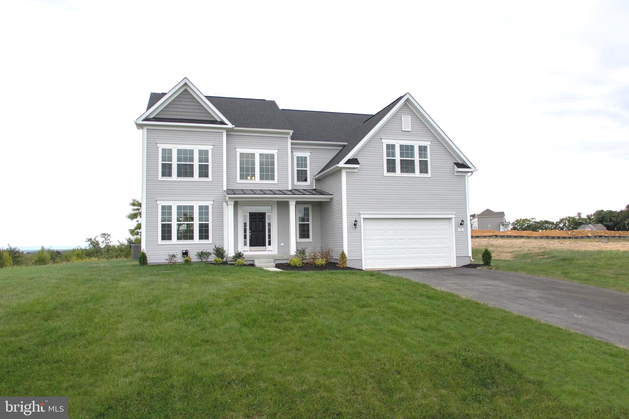 AVAILABLE NOW.Beautiful Home on .922 Acre home site with HUGE gourmet kitchen and views of the mountains! Wood flooring throughout the first level. Beautiful stone to ceiling gas fireplace. Gourmet kitchen with smart appliances, 12ft island, quartz counter tops, upgraded cabinets with crown molding, farm sink and a huge morning room with a great view and lots of natural light! Huge owners bedroom with 2 walk in closets, ceramic tile bathroom with soaking tub and stand up shower with frameless shower doors. These homes feature their own well for water and public sewage. Which means..no water bill! Schedule your private showing today!