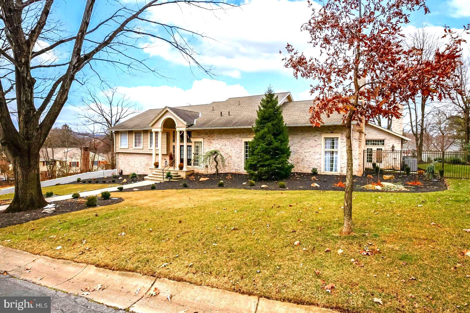 **Stunning** is the only word to describe this extraordinary five-bedroom residence in the heart of the highly sought-after Wyomissing School District. Offering more than 8,000 square feet of beautifully designed living space, this exceptional home showcases impeccable craftsmanship, timeless design, and understated elegance at every turn.

Every room is beautifully appointed, with a level of detail and sophistication worthy of the pages of a luxury home magazine. The floor plan is both impressive and inviting, creating an atmosphere that is grand without ever feeling overwhelming.

The main living areas feature soaring open-beam ceilings, striking fireplaces in both the living and family rooms, and a spectacular dining room highlighted by dramatic floor-to-ceiling corner windows that fill the space with natural light.

The heart of the home is the magnificent custom kitchen. Designed for both everyday living and entertaining, it features two expansive Quartz islands, custom white cabinetry, elegant designer lighting, a Wolf commercial-style nine-burner gas range with double ovens, and concealed Sub-Zero refrigerator and freezer units seamlessly integrated into the cabinetry. Additional highlights include a coffee station, an oversized walk-in pantry, a charming porcelain farmhouse prep sink, a convenient dumbwaiter, and abundant storage throughout. Every detail has been carefully considered, creating a kitchen that is as beautiful as it is functional.

Adjacent to the kitchen is an inviting breakfast area overlooking the patio through walls of glass, enhanced by a cathedral ceiling with warm wood accents that creates an open, airy feel. A convenient snack bar offers additional seating, making this the perfect gathering place for family and guests.

Also on the main level is a versatile flex room that can easily serve as a home office, library, children's playroom, or media room, along with a beautifully appointed full bath.

The upper level is thoughtfully designed across two levels. The luxurious primary suite serves as a true private retreat, featuring two spacious walk-in closets, custom vanities with classic vintage-inspired fixtures, a two-person sauna, an oversized tiled walk-in shower, and French doors leading to a private rooftop deck overlooking the pool and patio. It's the perfect place to enjoy spectacular evening sunsets.

Just outside the primary suite is an additional bedroom or private sitting room, ideal as an executive office or lounge. A few steps above are two generously sized bedrooms, two additional full baths, a convenient laundry room, and a private fifth bedroom suite complete with its own walk-in closet and full bath.

The finished lower level offers exceptional recreation and entertaining space with a large family room featuring a full wet bar and impressive stone fireplace. A dedicated fitness room opens into the current owner's art studio, with direct access to the immaculate four-car garage featuring durable epoxy flooring.

Outdoor living is every bit as impressive. Professionally landscaped grounds are enhanced by a full irrigation system, expansive stone patios, a relaxing spa, and a heated in-ground saltwater pool surrounded by attractive fencing—creating a private backyard retreat designed for entertaining and relaxation.

While this description highlights many of the home's outstanding features, it simply cannot capture the warmth, quality, and attention to detail found throughout. This is a home that must be experienced in person.

Schedule your private showing today and discover everything that makes **1504 Old Mill Road** one of Wyomissing's truly exceptional residences.