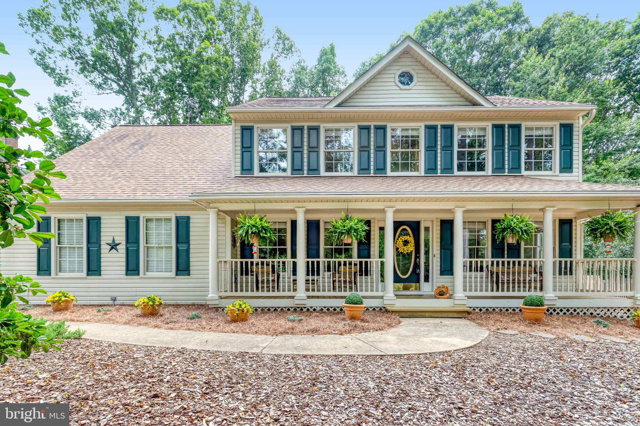 From the moment you turn into the freshly sealed driveway, this home feels special. Set on a beautifully landscaped 1-acre lot, it offers the kind of peace, privacy, and natural beauty that is getting harder and harder to find. Mature trees, colorful plantings, flagstone walkways, charming sitting areas, bird baths, lantern lighting, relaxing hammocks, and a cozy fire pit create an outdoor setting that feels more like a private park than a typical backyard.

Picture slow mornings on the welcoming front porch with a cup of coffee, listening to the birds as the day begins. In the evenings, gather around the fire pit, enjoy dinner beneath the gazebo, or relax on the spacious composite deck while overlooking your own quiet retreat. Every corner of the property invites you to pause, breathe, and enjoy the simple beauty of home.

The care and pride of ownership are clear from the moment you arrive. The owners have maintained this home with incredible attention to detail, completing thoughtful updates over the years while preserving its warmth and character. This is one of those rare homes that feels loved, comfortable, and well cared for in every way.

Inside, warm hardwood floors welcome you into a traditional yet inviting layout designed for both everyday living and easy entertaining. Formal living and dining rooms offer flexible spaces for gatherings, celebrations, quiet evenings, or simply spreading out and enjoying life at home. Natural light fills the rooms, creating a warm and cheerful feel throughout.

The kitchen is truly the heart of the home. A beautiful bay window above the sink frames peaceful backyard views, making even everyday routines feel enjoyable. With abundant cabinetry, stainless steel appliances, a gas stove, pantry storage, and a spacious breakfast area, this kitchen offers both charm and function. It is the kind of space where conversations linger, meals are shared, and everyone naturally wants to gather.

Just beyond the kitchen, the family room invites you to slow down and stay awhile. A beautiful brick fireplace with gas logs adds warmth, character, and a cozy focal point for chilly evenings. Whether hosting guests or enjoying a quiet night in, this room brings comfort and ease to daily living.

Beyond its beauty, this home offers something truly valuable: peace of mind. Major updates have already been completed, and the quality of construction is evident throughout. Built with energy-efficient 2x6 exterior walls, enhanced R-56 attic insulation, and R-19 wall insulation, the home was designed for year-round comfort while helping keep utility costs lower. City water, city sewer, natural gas service, and a fully automatic whole-house Generac generator add an extra layer of convenience and security.

The oversized garage is another standout feature, offering custom cabinetry, a dedicated storage room, fresh paint, an insulated garage door, and a new opener installed in 2025. A custom-built shed with French doors provides even more space for storage, hobbies, tools, or workspace needs.

The list of improvements reflects years of careful ownership. The architectural shingle roof was replaced in 2017 and includes ridge vents and a power exhaust ventilation fan. The home is serviced by a Trane high-efficiency dual-fuel HVAC system with gas heat, a heat pump, and electronic air filtration. A high-efficiency gas power-vented water heater was installed in 2016. Kitchen and appliance updates include a dishwasher installed in 2025, microwave and gas range in 2024, refrigerator in 2018, and washer and dryer in 2017. Exterior trim and window trim have been wrapped in aluminum to help reduce maintenance, while custom blinds, upgraded light fixtures, and custom wood molding bring added warmth and detail inside.

The location offers the best of both worlds. While the property feels tucked away in its own peaceful setting, it remains just minutes from shopping, restaurants, parks, schools, and major commuter routes. It i