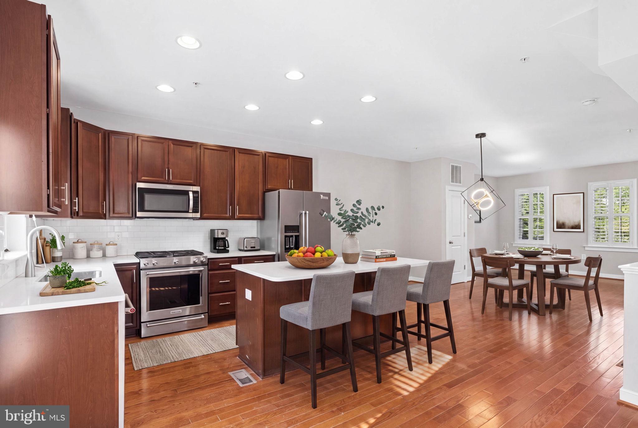 422 Virginia Avenue — a Towson Mews end-of-group luxury townhome with upgrades galore, offering 1,944 square feet of impeccable, turn-key living across four sun-filled levels. The perfect choice for busy professionals, downsizers, and first-time buyers seeking convenience and a residence that truly sparkles.

Ultra-convenient to the blossoming Towson hub, this spotless gem is just a few blocks from Cinemark, Towson Town Center, and a myriad of casual and upscale restaurants — Cunningham's Café and Bakery, the Atlas Group's Perennial, Towson Hot Bagels, Towson Tavern, and Towson Row with its Whole Foods Market. The location offers a zippy commute to Towson University, Greater Baltimore Medical Center, and University of Maryland St. Joseph Medical Center, with a Walk Score of 93 putting shopping, dining, parks, fitness centers, and pubs all minutes from your door.

Built in 2018 with an appreciation for detail and quality, this home offers three bedrooms, four full bathrooms, and a sun-filled fourth-level loft that opens to a private terrace — an ideal retreat for a home office, lounge, or guest space. Wide-plank hardwood floors run throughout the upper levels. The gourmet kitchen is appointed with premium stainless steel KitchenAid appliances, quartz countertops, custom 42" cabinetry, an undermount sink, and recessed lighting. Refined touches continue throughout: plantation shutters, Hunter Douglas blinds, dimmers, custom shelving, a smart-home tech package, and multiple decks plus the rooftop terrace for easy indoor-outdoor living.

A bona fide two-car attached garage means parking is always available, and James Hardie cement siding delivers low-maintenance peace of mind. The home was built energy-smart, with high-performance windows, an advanced insulation and energy-seal program, and a HERS-rated efficiency package.

Homes this polished, in a location this walkable, don't last long in Towson. Coming soon!