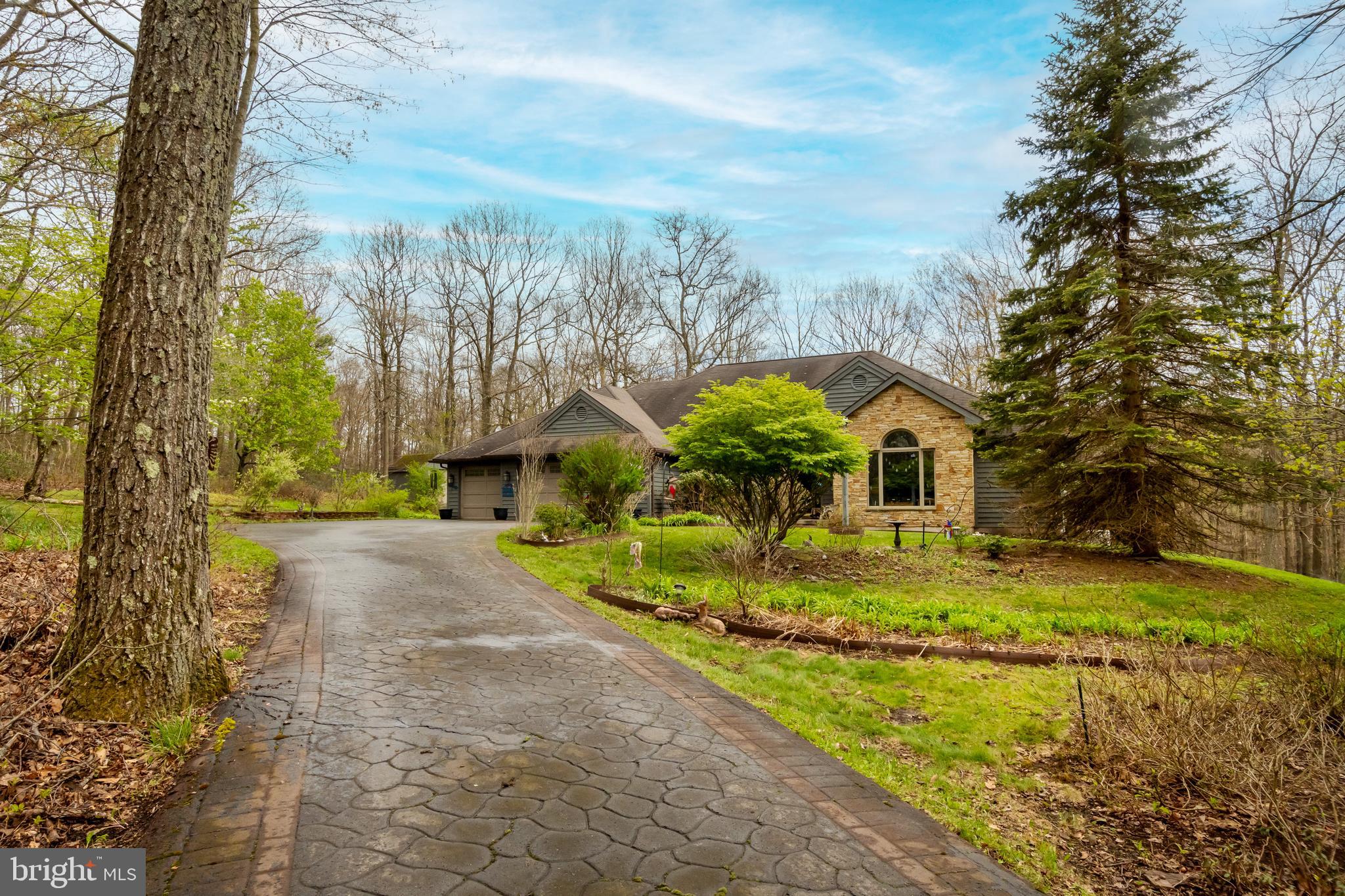 Custom-built home thoughtfully placed on 7.4 scenic acres in the Loch Glade community. Featuring three spacious bedrooms and 3.5 baths, the layout is designed for comfortable every day one-level living with a large family room for entertaining. The two-sided wood burning stone fireplace adds warmth to both the living room, kitchen, sunroom, and dining room. An abundance of windows (Andersen) allows for wonderful natural light to every room during any season. Sitting on a full basement, you have additional living space available below, along with a huge storage room and workshop. There’s a nice blend of yard and woods, complemented by a rear deck, lower-level patio and a screened gazebo—ideal for relaxing or hosting gatherings. A whole-house generator adds an extra layer of security and reliability year-round, and the 3-car garage and two sheds are another bonus. Recent updates include a new furnace. Community lake access nearby with a swim dock and kayak rack, and nearby is a pavilion area. Located just a short drive from Deep Creek Lake, you’ll enjoy easy access to recreation while still coming home to a peaceful setting.
