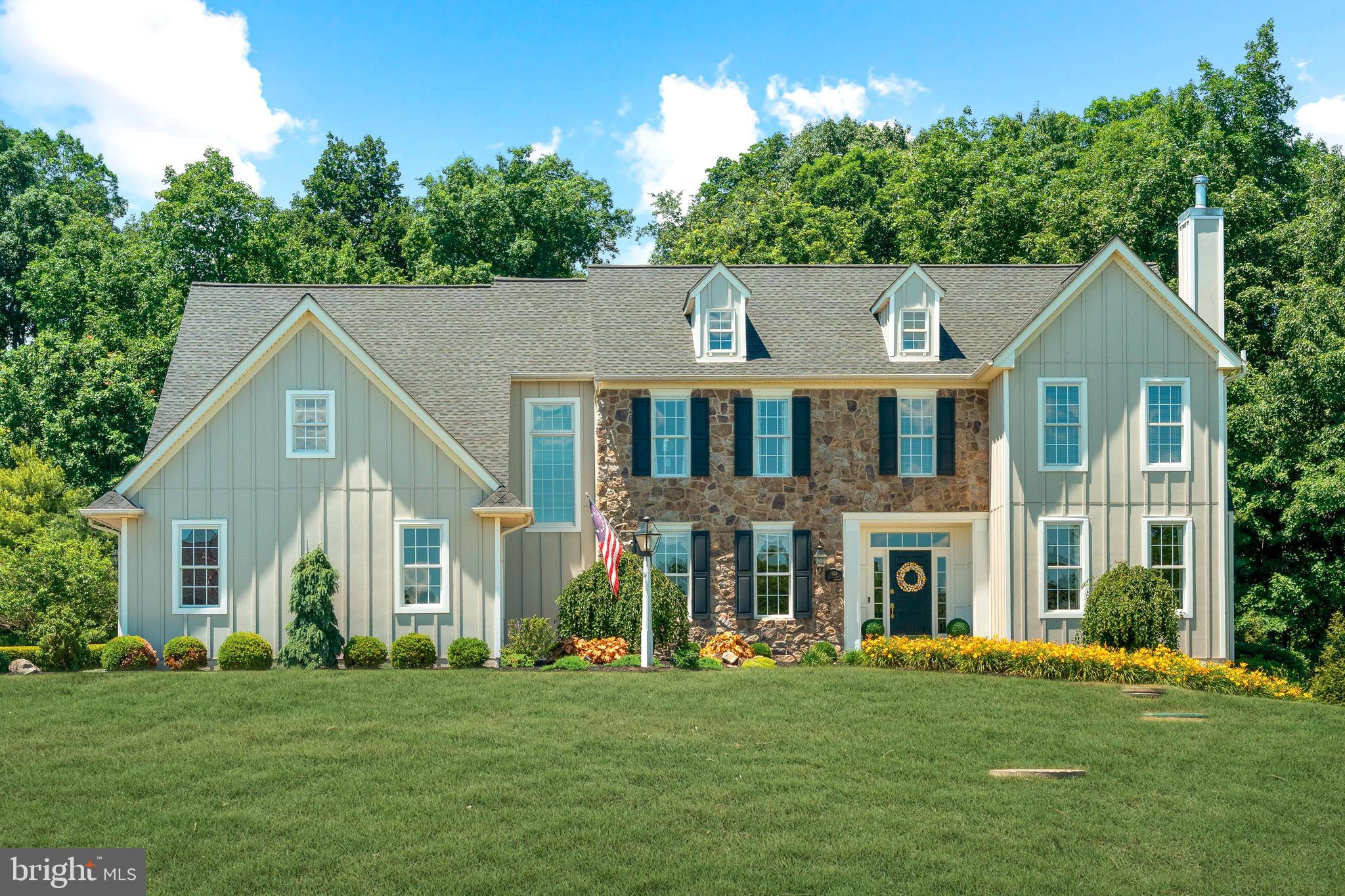 Nestled at the end of an exclusive nine-home cul-de-sac in the rolling hills of Bedminster Township, this meticulously maintained David Knipe custom home blends timeless craftsmanship, thoughtful updates, and an exceptional outdoor living experience. Set on over an acre of mature landscaping and gardens that provide a spring-to-summer concert of perennial blooms, this nearly 5,000-square-foot residence captures the quintessential charm and beauty of Bucks County living.

A striking first impression begins in the substantial foyer, where a graceful winding staircase and grand Palladian windows fill the home with natural light. Architectural details abound, including custom wide-plank pine floors throughout the first level, extensive crown molding, wainscoting, and quality millwork. The inviting living room features a wood-burning fireplace insert with a newer forced-air convection system designed to enhance heat distribution throughout the home. An adjacent sunroom brings the outdoors in during every season and provides direct access to a bluestone patio. A formal dining room, currently enjoyed as a music room, and a conveniently located powder room complete this portion of the home.

At the heart of the residence, the great room and kitchen offer comfortable gathering spaces with picturesque views of the backyard, plantation shutters, and French doors leading to one of the property's most exceptional features. The covered outdoor pavilion creates a true four-season retreat, complete with a wood-burning fireplace, infrared heating, ceiling fan, and bistro lighting—an ideal setting for entertaining or relaxing throughout the year.

The updated chef's kitchen features granite countertops, a prep sink, quality appliances, a high efficiency induction cooktop (also fully plumbed for gas), and abundant workspace for both everyday living and special occasions. Beyond the kitchen, a well-appointed laundry and mudroom includes a utility sink and newer Electrolux washer and dryer. The oversized three-car garage offers professionally finished flooring and generous storage.

Upstairs, the primary suite features newly installed hardwood flooring, a sitting room, walk-in closet, and a recently refreshed bath with jetted soaking tub, double vanities, and separate shower. Four additional bedrooms, two with new hardwood, provide flexibility for family, guests, or home office needs and are complemented by a secondary staircase with oversized window leading directly to the great room below. A refreshed hall bath with double vanity serves the secondary bedrooms.

The expansive finished lower level, complete with heat and a powder room, offers endless possibilities for recreation, fitness, media, hobbies, and entertaining. Three separate storage areas provide exceptional organizational space.

The grounds continue to impress with a fenced six-bed raised garden featuring irrigation and lighting for gardening enthusiasts, a generously sized shed with electric service, invisible pet fencing, a Generac whole-house generator, and a comprehensive security system. Significant updates to major systems—including the septic system, roof, HVAC equipment, and well pump—provide peace of mind, with many other additional updates in the comprehensive attached list.

Enjoy the serenity and natural beauty of Bedminster Township while remaining conveniently close to Doylestown, New Hope, Lake Nockamixon, Peace Valley Park, shopping, dining, and major commuting routes to Philadelphia, New Jersey, the Lehigh Valley, and New York. This is a rare opportunity to enjoy the privacy, character, and lifestyle that define Bucks County at its best.