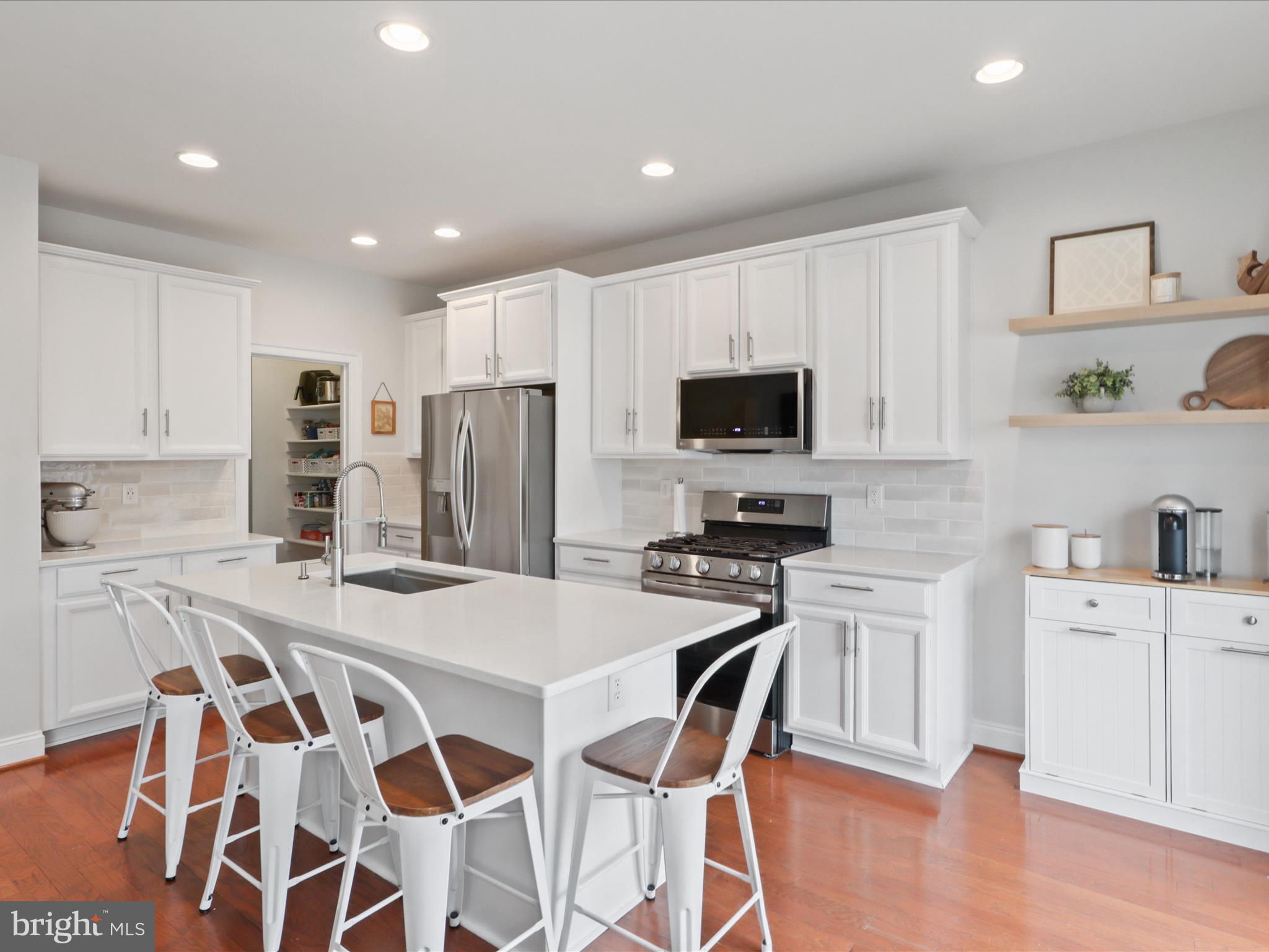 Beautifully updated townhome in Haymarket's Villages of Piedmont neighborhood! Over 2000 sqft on 3 finished levels with a 2-car garage. Almost $40k in recent upgrades including a new roof, deck, kitchen countertops & island extension, kitchen cabinet painting, backsplash, appliances, and fresh paint. Enjoy an oversized walk-in pantry, a cozy built-in fireplace, and walk-in primary closet. Situated on a private front lot facing trees and located within a highly-rated school pyramid. Enjoy all the Villages of Piedmont has to offer, including pools, clubhouses, tennis, pickleball and basketball courts, tot lots, dog park, and access to Leopold's Preserve. Close to 66, 29, 15, Jiffy Lube Live, wineries and breweries, Manassas Battlefield, and excellent shopping and dining! Assumable VA loan @ 4.85%