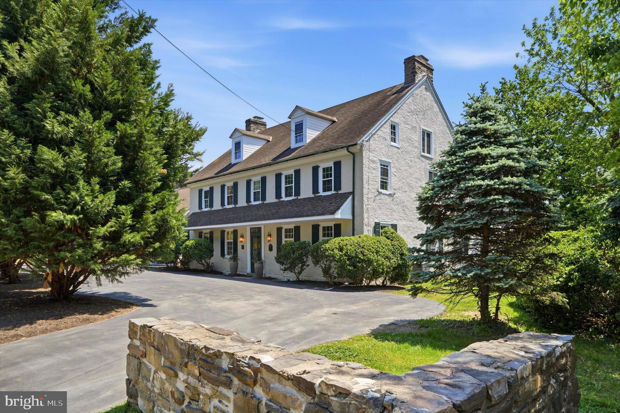 500 E. Mill Road is a beautifully restored historic residence that blends timeless character with thoughtful modern updates, set among some of the area’s most sought-after historic homes. Dating back to the early 1800s and once associated with the historic Sunnybrook estate, this remarkable stone home offers a rare combination of history, craftsmanship, and modern livability.
A wide center hallway welcomes you into the home, where the dining room and kitchen are set just off to one side and multiple living and entertaining spaces unfold to the other. The kitchen features Bosch appliances and generous space for everyday living and entertaining. Just steps away, a walk-in pantry with a second refrigerator provides additional storage and convenience.
Toward the rear of the home is the great room, part of the original structure, offering a true sense of history highlighted by exposed wood beams and a massive fireplace, a defining focal point of the space. A separate mini bar off the great room creates an ideal setting for entertaining.
Upstairs, the spacious primary suite features a separate sitting area, walk-in closet, and an ensuite bath with heated floors. Two spacious secondary bedrooms, a shared bath, and convenient second-floor laundry complete the level.
The third floor offers two additional bedrooms and a shared bathroom, providing excellent options for guests, home office, or extended living needs.
Throughout the home, original details, including wide-plank hardwood floors, multiple fireplaces, custom millwork, and built-ins, have been carefully preserved and paired with tasteful renovations designed for today’s lifestyle. The newly added two-car garage connects to a functional mud room entry. Additional modern conveniences include multi-zone central air conditioning.
Set on beautifully landscaped grounds with mature plantings, this home presents a rare opportunity to own a truly special historic property thoughtfully updated for modern living.