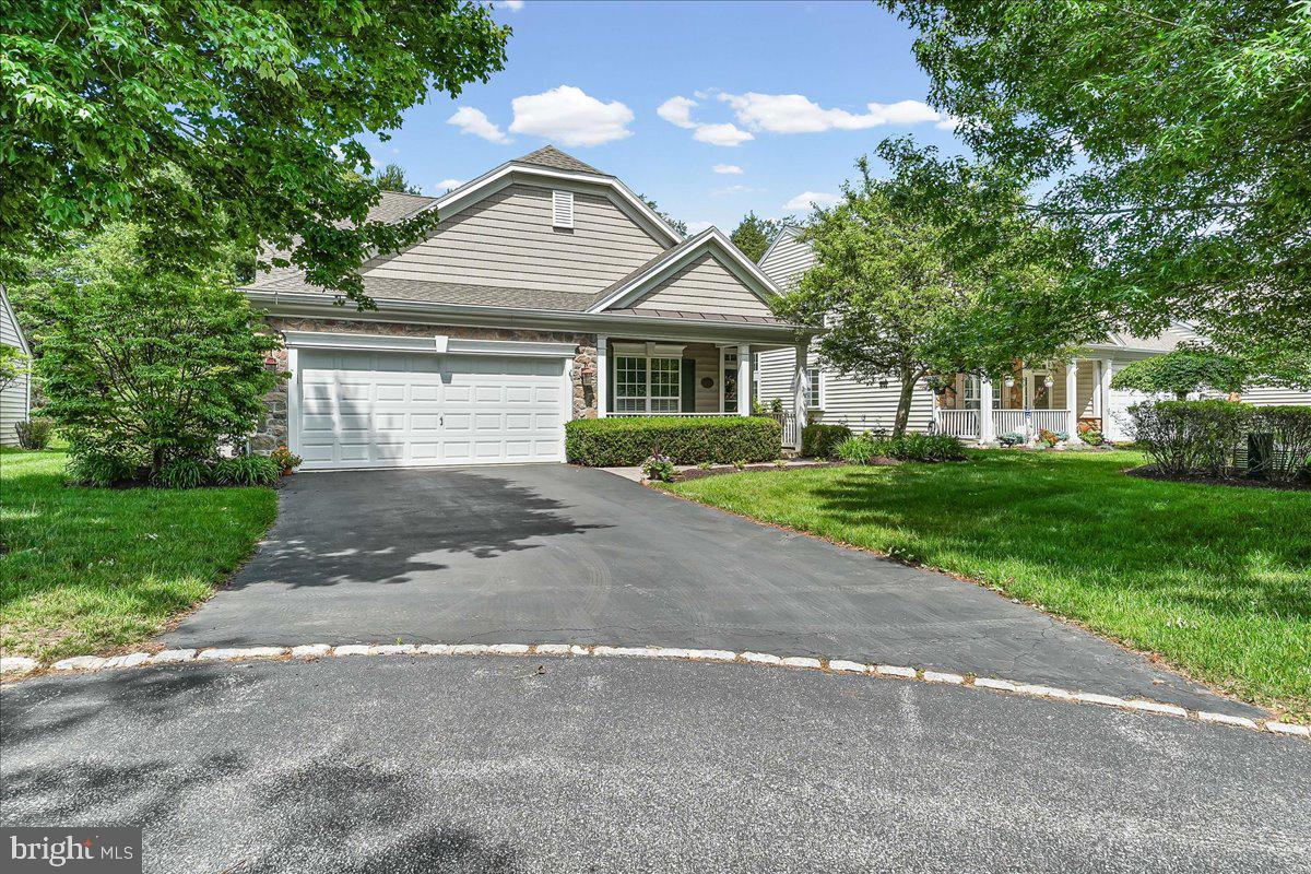 Classic, stylish, well-maintained... all come to mind when you walk into 112 Petunia Drive!  This home is in excellent condition and it has been lovingly maintained!  When you walk in the front door you will love the foyer and entrance way of this Navesink model.  The beautiful staircase and the perfect sized living room and dining room.  Take a walk back to the heart of the home... the kitchen and family rooms.  The kitchen has lovely cherry cabinets, granite counter tops and modern stainless steel appliances.  The family room is very large with a gas fireplace and soaring ceilings!  The views out the back of the home are so wonderful and private as you take to the outdoors for entertaining on the paver patio.  This patio is really well done and layout for everyday dining or for a nice get-together with family and friends.  The first-floor primary bedroom is huge!  And the walk-in closet has been upgraded with shelving and drawers that make organizing your clothes a piece of cake!  The primary bathroom is so spacious and the shower stall is one of the largest you've seen!  There is also another bedroom and full bath on the first floor.  The closet in this bedroom is also upgraded with custom organizing for all your storing needs.  Need an office?  An exercise area?  Place for the grand kids to hang out?  The second floor loft is perfect!  And there is a third bedroom and full bath on the second floor so your guests can have a private space of their own!  All of this in the ever-popular Traditions at Longwood where you're not only buying a home that is beautiful... you're making a lifestyle change to be carefree and easy!
