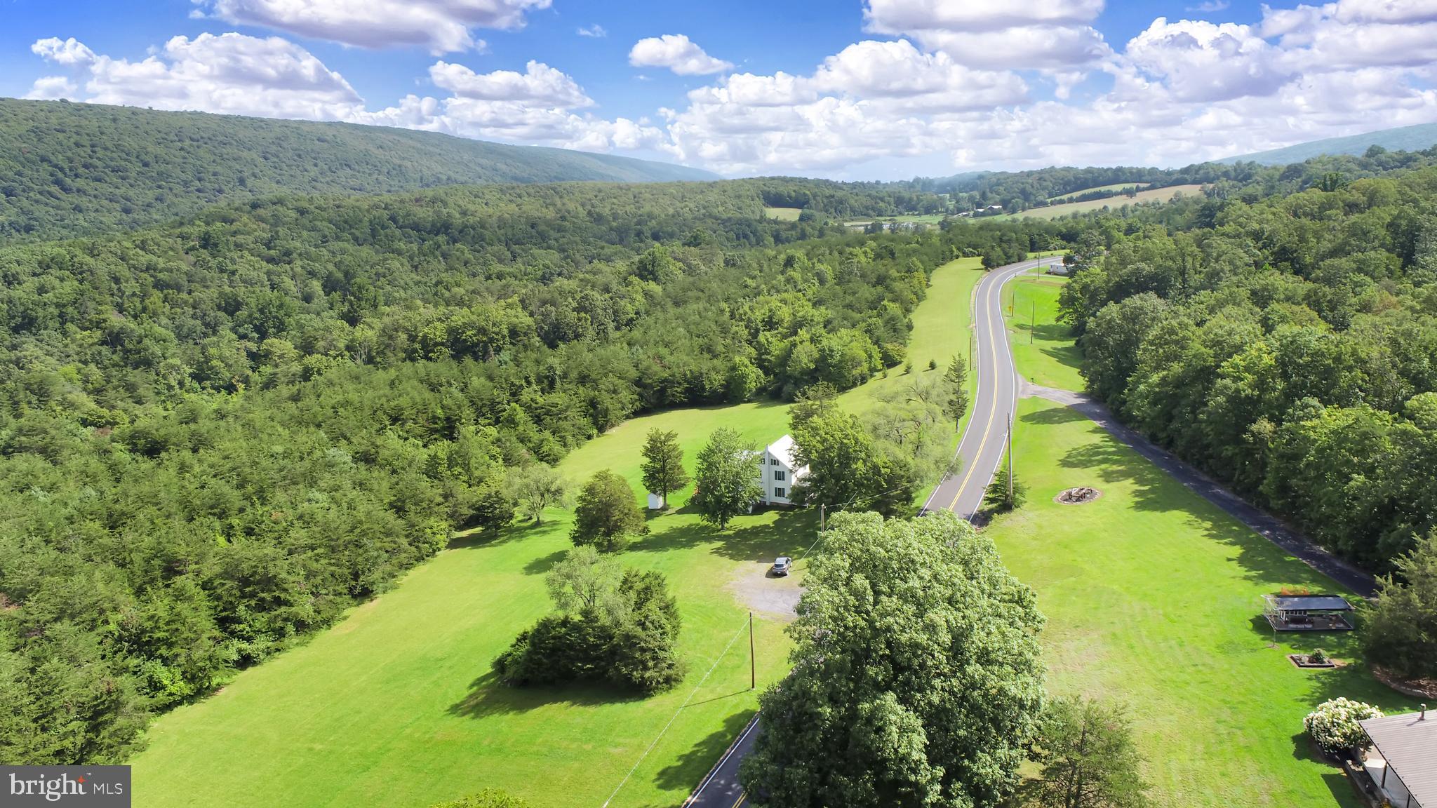 Here is a rare opportunity to own 159 acres in Perry County. North East Madison Twn. Has no zoning. A 2 story colonial home could serve many purposes. There is almost a mile of road frontage on Route 850. There is over a mile of border to thousands of acres of State Game Lands creating endless hunting. A great property for your personal hunting or bring the hunting camp. Lots of paths and trails for the ATV's.Thinking outside the box might include a campground possibility , grazing area for the horses, sheep and goats. For agriculture this property could house commercial poultry facilities. There is some timber.  A lot of the area is timber and brush growth due to not being farmed for many years. This provides great cover for wildlife. The views of the surrounding mountains are spectacular. Relax on the deck and enjoy the wildlife appearing in the summer evenings. A great spot to sit by a fire on a winter evening with the snowflakes drifting past the windows. Also walk on paths that are similar to when the first settlers passed through to adjoining valley encountering hostile natives.