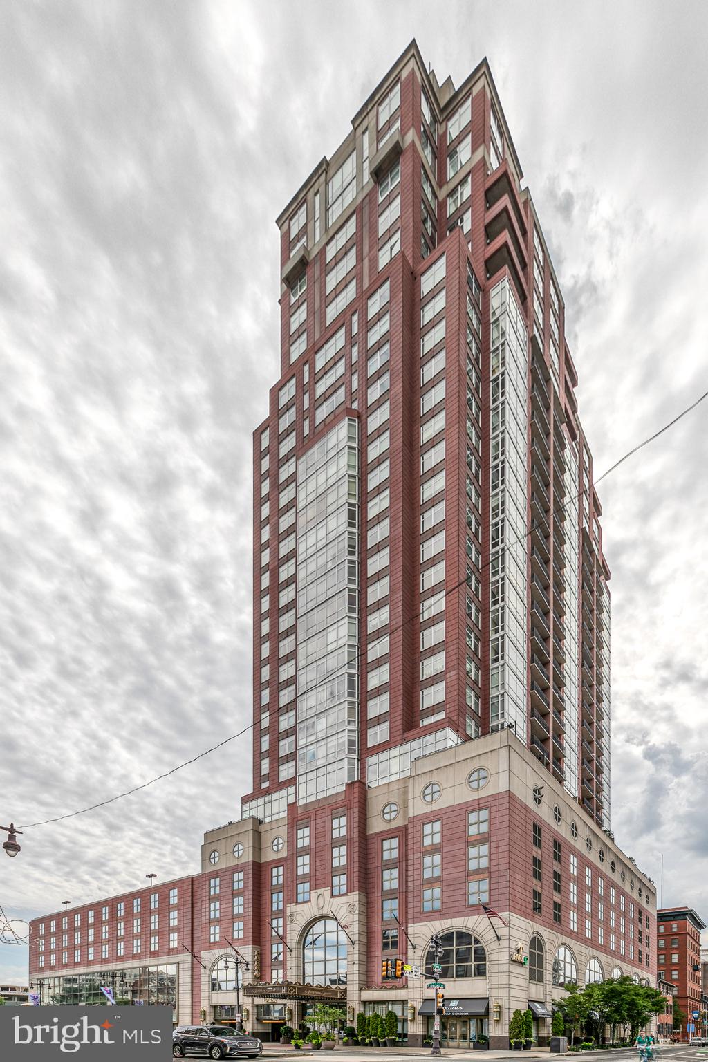Mozart Luxury Suite in the spectacular Symphony House! Incredible opportunity to purchase this sun-filled, 2395 sq ft, 2 bedroom, den, 2.5 bath condominium with balcony, 2 car parking, 2 storage spaces, dramatic east and south views, crown molding throughout, electric window blinds, main bedroom suite with 4 piece bath and two huge walk in closets with built-ins. This property is two units combined into one and has incredible sunrise and sunset views.  Enter into foyer area with wood flooring, coat closet and double closet with full sized, front load Bosch washer and dryer, plus additional storage and half bath with pedestal sink. Bedroom suite with large window, carpeting, southern view, linen closet, walk in closet and full tile bath, stall shower with glass enclosure and double vanity.  Handsome, fully equipped kitchen with wood flooring, granite bar counter, recessed lighting,  stainless steel Viking 6-burner stove and appliances, wine cooler, eye level oven and microwave, large dining area with floor to ceiling window and door to balcony with big, southern sky view! Light filled, wide open living, dining area, kitchen area with wood floors, cabinetry and entertainment area. Spacious den with floor to ceiling window and wood floors. Unusually expansive main bedroom suite features carpeting, floor to ceiling windows, two huge walk in closets with built in shelving and cabinetry, four piece tile bath with double vanity and stall shower. Additional access door to hallway. The Symphony House offers a 24/7 concierge, doorman, fitness center, bike share, incredible heated indoor pool and sauna, pristine outdoor spaces, library, club, dining salons, wine cellar and a catering facility. Nestled in a prime and convenient Avenue of the Arts location close to the theatre district, fine restaurants, shops, cafes and more! Parking #: 569 & 570Storage #: L70 & L71