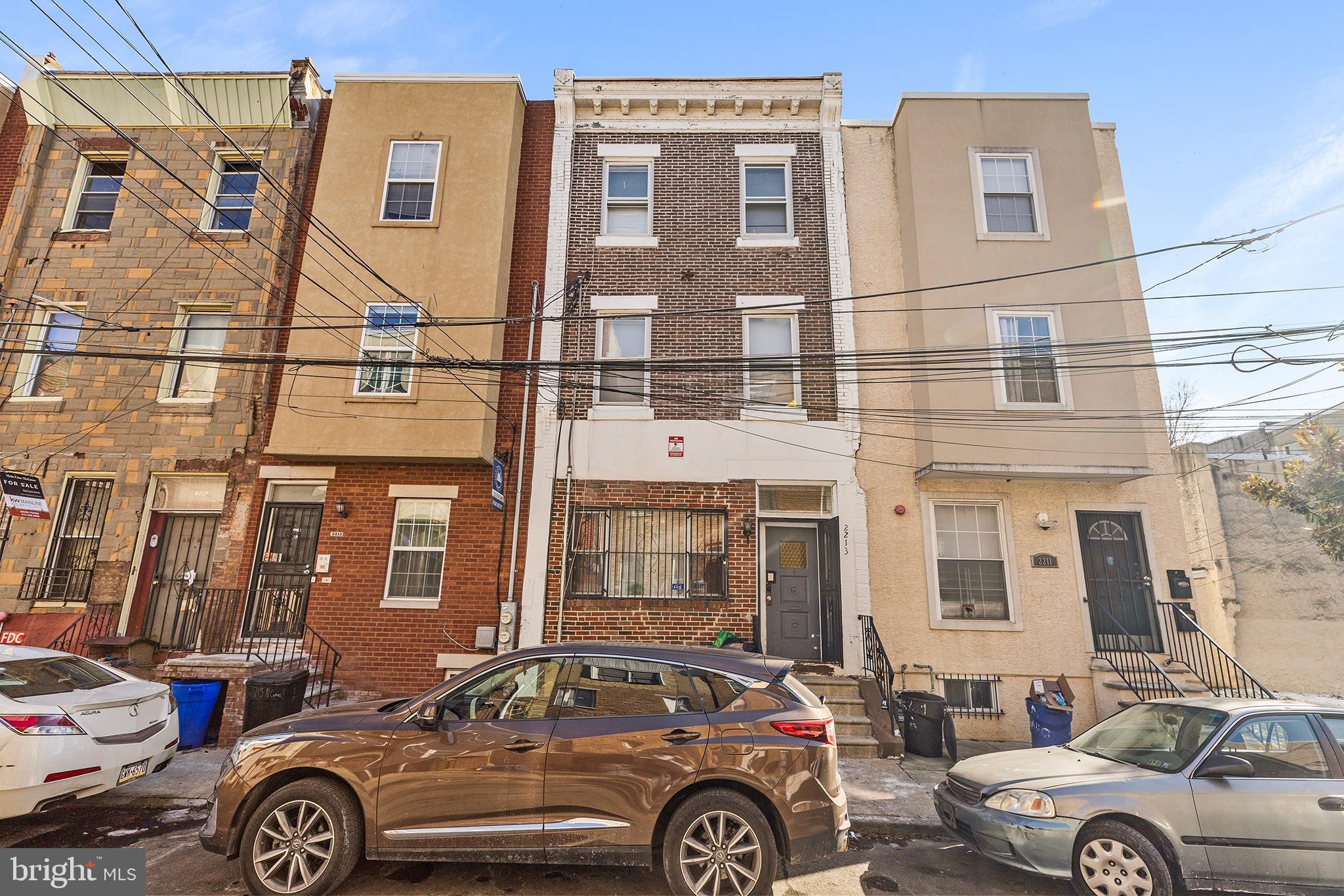 Fully rented bi-level duplex in the heart of Hartranft—an ideal turnkey investment just blocks from Temple University with potential monthly rental income of  $3,000. Unit 1 spans the first floor and most of the second floor. It offers a spacious living room with a large front window and decorative fireplace. The kitchen features stainless steel appliances and a built-in buffet cabinet, with convenient access to a rear laundry room and full bathroom with stall shower. Access  the large, fenced-in rear yard directly from the kitchen—perfect for outdoor space. A generously sized bedroom completes the first floor. Upstairs, you’ll find two additional bedrooms with hardwood floors; the front primary bedroom boasts a bay window and another decorative fireplace. A full hall bathroom with stall shower serves the second level. Unit 2 is also bi-level, beginning on the second floor with one bedroom. The upper level features a well-appointed kitchen with wood cabinetry and stainless steel appliances, two large bedrooms, and a full hall bathroom. Located in a prime area close to Temple University, public transportation, restaurants, parks, and neighborhood conveniences, this income-producing property offers strong rental demand and long-term value. Mortgage savings may be available for buyers of this listing.
