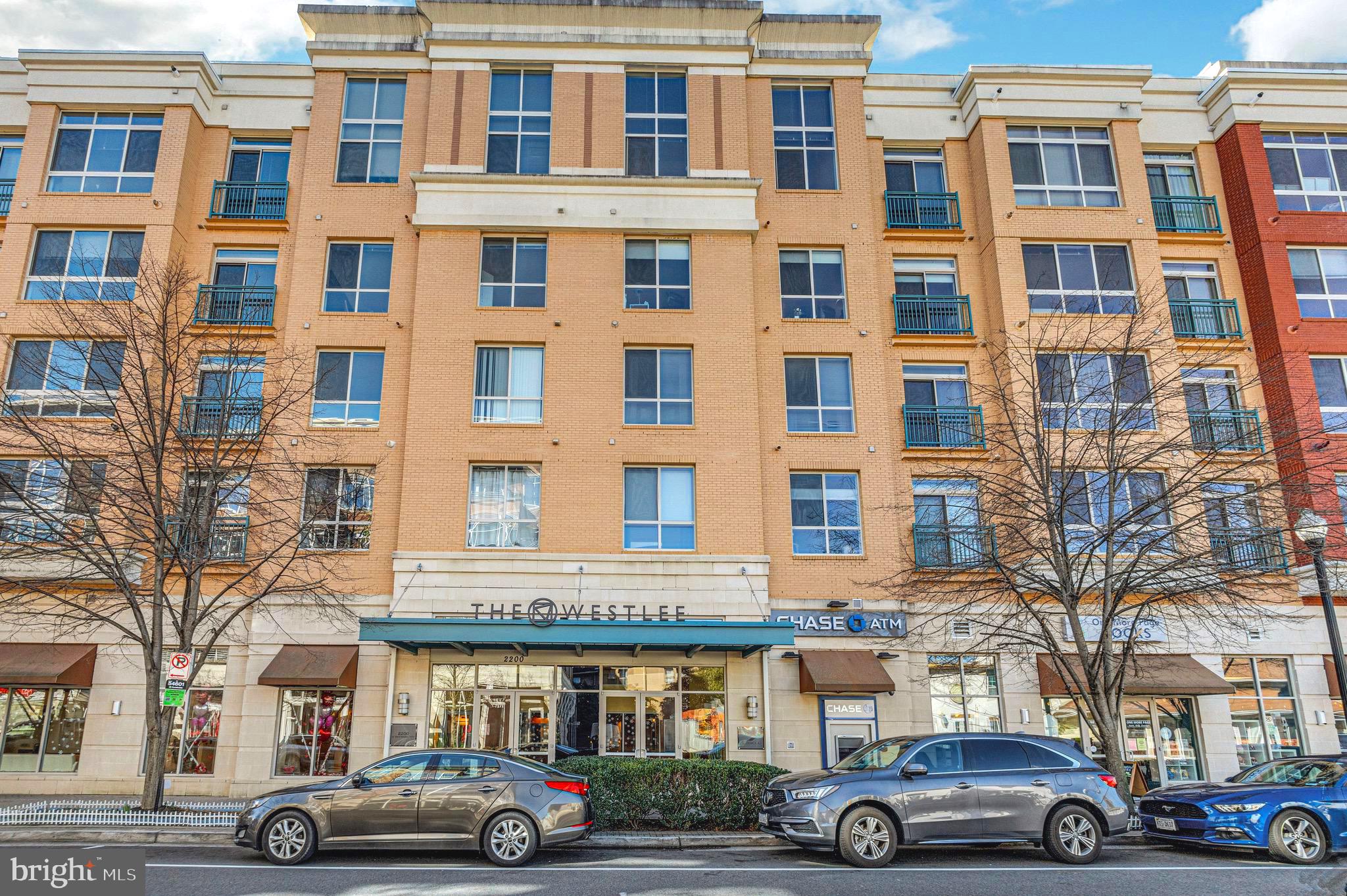 Located in one of Arlington’s most sought-after neighborhoods, East Falls Church, this well-maintained contemporary condo offers a thoughtful balance of comfort, functionality, and convenience. Floor-to-ceiling southeast-facing windows paired with high ceilings bring in abundant natural light, creating a bright and open living environment. The main living area features wood flooring and expansive windows with treetop views, providing a sense of privacy and a pleasant connection to the outdoors. The kitchen is well-equipped with granite countertops, maple cabinetry, stainless steel appliances and a center island suitable for both everyday use and casual gatherings. The bedroom is well-proportioned, with a sliding glass door and Juliet balcony allowing for consistent natural light. Two closets, including a walk-in, offer practical storage. The bathroom features a dual-access layout, soaking tub, and clean, updated finishes. Recent improvements include HVAC (2022), dishwasher (2023), washer & dryer (2024), and refrigerator (2025). The unit has been freshly painted and is move-in ready.WestLee is a well-managed and established building with professional on-site management and a friendly concierge available seven days a week. Amenities include a fitness center, party room, landscaped courtyard, bicycle storage, and package handling. Ideally located within walking distance to East Falls Church Metro and near the Arlington/DC line, this home offers easy access to I-66 and a seamless commute into DC, Tysons, and the Pentagon—making it an excellent choice for commuters. Everyday conveniences, dining, and the W&OD Trail are all close by.