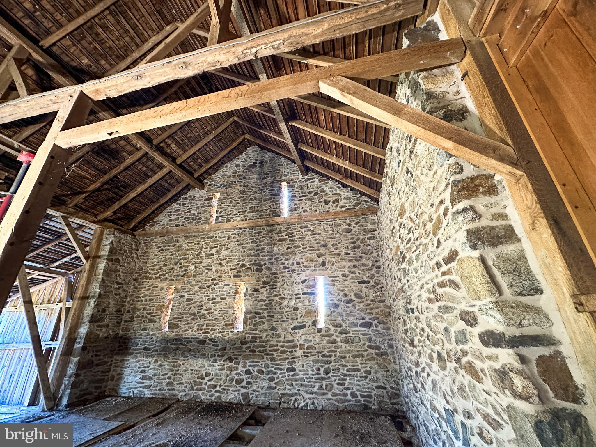 Tired of seeing the same housing options that don't capture your sense of what home should be?  Available now is the early 19th-century Stone Bank Barn on Moore Road that so many have seen.  It's an iconic piece of Chester County's rich history.   Bank barns like this can become a spectacular residence., but your imagination and desire are critical. Situated on a bucolic 1.9-acre lot with a  spring fed stream in the  Downingtown Area School District.  This hand-built "old stoney"  is complete with 2-foot-thick stone gable ends,  has all the elements of a massive timber-framed work of art layered with generations of history overlooking a lovely pond, breezy willow stream bank, and a protected location.  The barn is  so close to the hiking, biking, and boating network of Marsh Creek State Park, and you enjoy multiple entry access points.  Perc tests and septic details are known.   This is not a drill; 1this barn has amazing stone, complete with massive quoins and a gorgeous tan mortar.  Fully pointed inside and out ready for your spectacular windows and imagination.  The square footage calculation contains only the main floor and does NOT include the 68'X15' forebay section or the unfinished lower level, which walks out to daylight.  
Shown by appointment only.