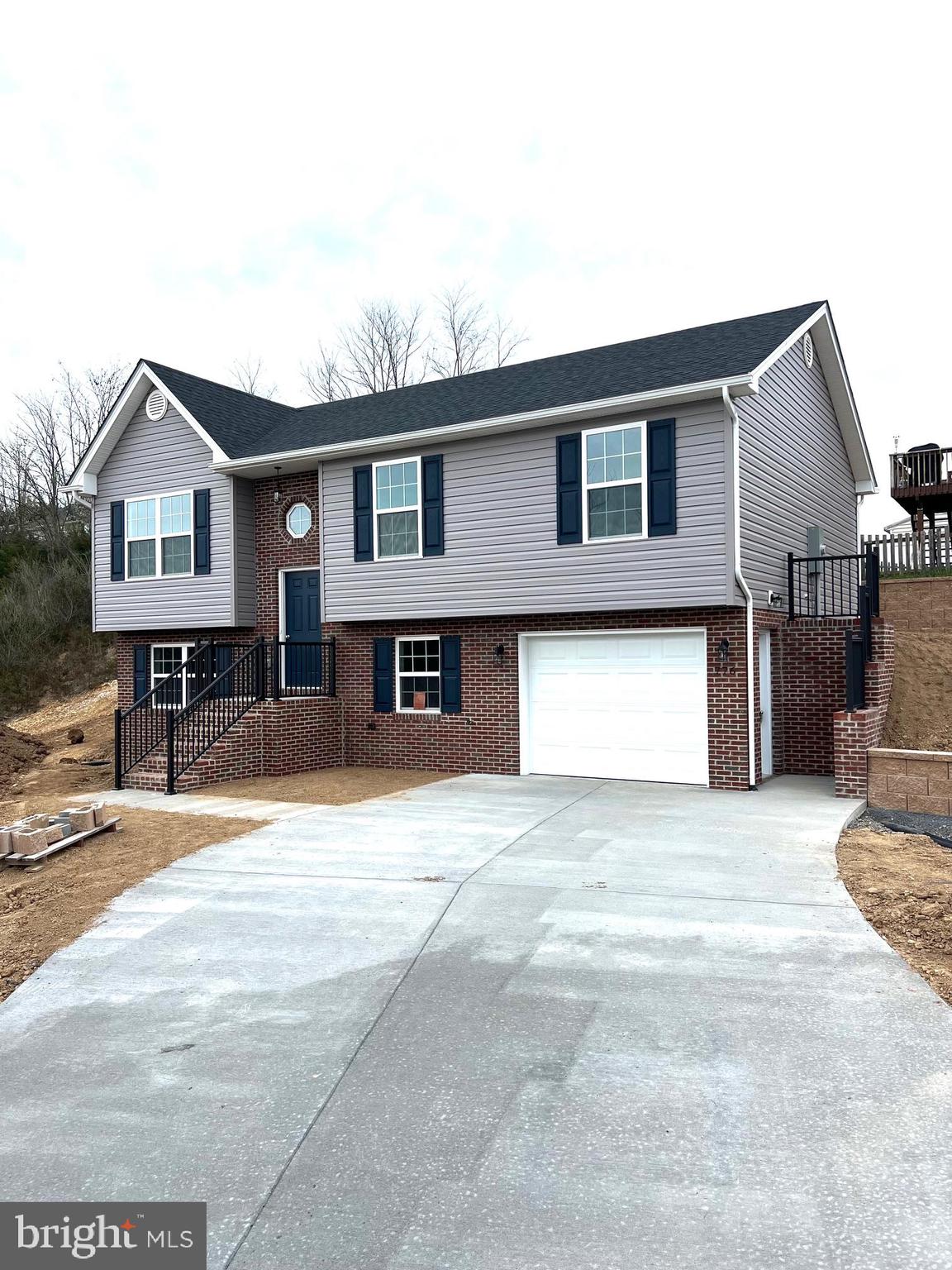 This new home is under roof!    Located in Madison Heights subdivision!  Situated on a corner lot and nestled on a knoll offering mountain views.  At the end of fulton drive - and backs up to Island Farms which is  100+/- acres and part of it is in an easement - so it will not be developed!  Open floor plan with 3 beds and 2 full baths; the primary bedroom has its own full bath!   The open kitchen leaves room for an island and features granite countertops & white cabinetry and stainless appliances The great room is ideal for entertaining and opens to the dining and kitchen!   It features an unfinished basement with a rough-in & laundry hook-up!  A one-car garage as well!  Outside you can enjoy the large front and side yard!  Or relax on the back Patio ( 8 x 40) constructed of patio pavers!  Concrete driveway & sidewalks to finish it out.   Welcome to your new home!  Delivery April 2024.  Brick to grade on the front of the home.