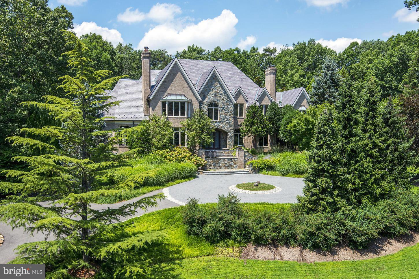 Stone & brick home by Michael Bowman, private double lot (3.83acre) 7100 sq ft, qualty thrghout: custom millwork & iron work, slate roof w/ copper gutters, 7 fp, gas generator,outdoor space w/ nod to Japanese garden & Appalachian woodlands; surreal waterfall & creek built w/ reinforced concrete, prized Koi fish & meditation house, lighted tenns court. Top rated Flint Hill School close by(4 miles).