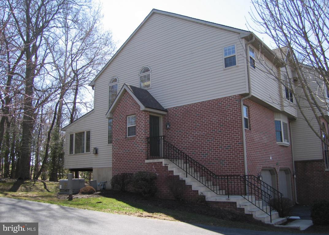 A light-filled low-maintenance end-unit townhome with 1600+ sq. ft, AND a 3-car garage! Open plan, lg. room sizes, ceramic tiled kitchen tastefully renovated in 2014, fresh flooring in 2014, and the unit was freshly painted with neutral colors in 2015. Many windows including bays, transoms, and 5 skylights maintained by HOA.  Wooded exterior views, backing up to trees offers privacy.