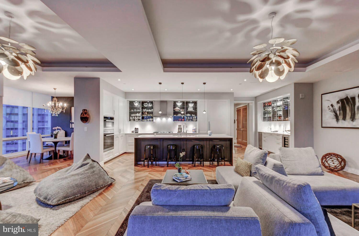 Welcome to the Four Seasons Private Residences in the heart of Harbor East, where luxury, location, and lifestyle converge.  From the 23rd floor, this gorgeous 2-bedroom, 2.5-bathroom residence offers spectacular  views of the Inner Harbor and marina and the Baltimore city skyline through  floor-to-ceiling windows.  This refined residence features rich walnut herringbone flooring, a gas fireplace, and high-end finishes throughout. The gourmet kitchen is outfitted with elegant cabinetry, a gas cooktop, wall oven, huge island with breakfast bar, and elegant quartz countertops. The adjacent dining area and wet bar with sink and wine fridge are ideal for entertaining or for a quiet night at home.  The primary suite includes a custom walk-in closet and a luxurious marble bathroom with double sinks, a large soaking tub, and separate shower. A second bedroom, also nicely sized, offers comfort and privacy for guests or family.
Enjoy your morning coffee or evening wine on the private balcony, and enjoy the shimmering waterfront and Baltimore skyline.  As a resident, you’ll have exclusive access to the private 28th-floor amenity level featuring an indoor saltwater infinity pool, sauna, outdoor deck, fitness center, meeting rooms, and lounging areas — plus a dog-walking area for your furry family members.  You’ll also enjoy full access to all hotel amenities, including the outdoor pool and valet services.  This property comes with one dedicated parking space in the garage with easy resident access.   The Four Seasons features four on-site restaurants, and many amazing dining options just a short walk away in Harbor East and Fells Point.  Shopping, parks, harbor activities, museums, and miles scenic waterfront walkways are all close enough to enjoy every day.  Experience luxury living at the Four Seasons, it’s more than a residence, it’s a lifestyle.