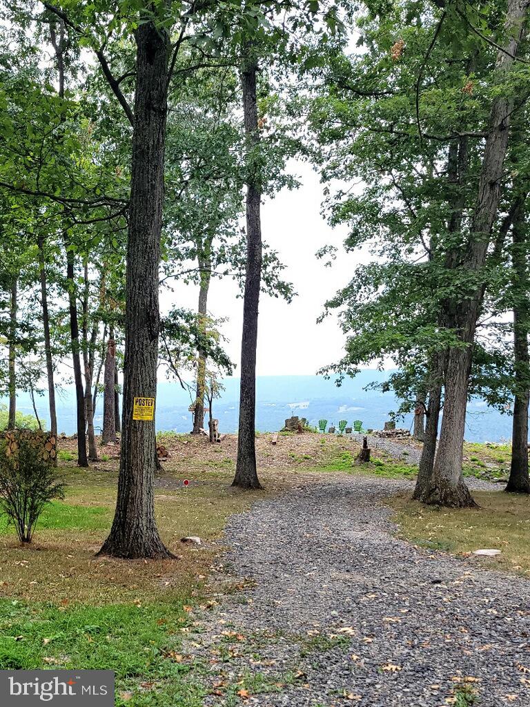 The most amazing views!!!! Would be a great location to build your AirB&B, weekend get-a-way, or enjoy it just as it is with little sleeping cabin with electric.  Located in White Cliffs of Ritter's Hidden Valley Estates.  Perched on top east side of North Dillon Mountain you will experience year round, astonishing views overlooking Cacapon River Valley and Bear garden Mountain.  The 5.051 acres with electric and two sheds (a he shed and a she shed)Perfect location for permanent home or a peaceful week-end get-a-way.  The 1624 acre subdivision offers 15 miles of peaceful country roads (you can ride your ATV's, hike, and walk.   Community offers fishing and swimming lakes, beach area. temnis courts,  and picnic/pavillion area. There is no HOA however perpetual Road & Park Maintenance Fees apply