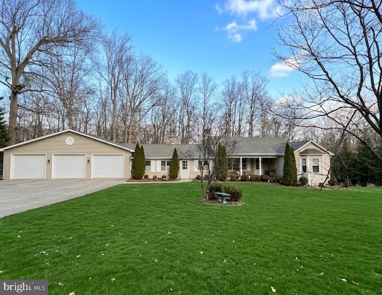 Welcome to your private retreat surrounded by nature! Nestled on a beautiful, expansive lot with mature trees and scenic views, this home offers the perfect blend of comfort, space, and tranquility. Step inside to a warm and inviting main level featuring hardwood floors, a spacious living room with exposed beams and a cozy fireplace, and large windows that bring in natural light and peaceful outdoor views. The open dining area flows seamlessly into the kitchen, offering plenty of cabinet space and room to gather. The main level includes two well-sized bedrooms and a full bathroom, providing convenient one-level living. Downstairs, the finished lower level offers additional flexible space, including a third bedroom, second full bathroom, and room for a rec area, home office, or guest suite. Enjoy outdoor living at its best with a large deck, perfect for entertaining, grilling, or simply relaxing while taking in the serene backyard setting. The property offers plenty of open space along with wooded privacy, creating a peaceful, retreat-like atmosphere. With solid bones, generous living space, and incredible outdoor surroundings, this home is full of opportunity to make it your own. Conveniently located while still offering privacy, don’t miss your chance to own this unique property!