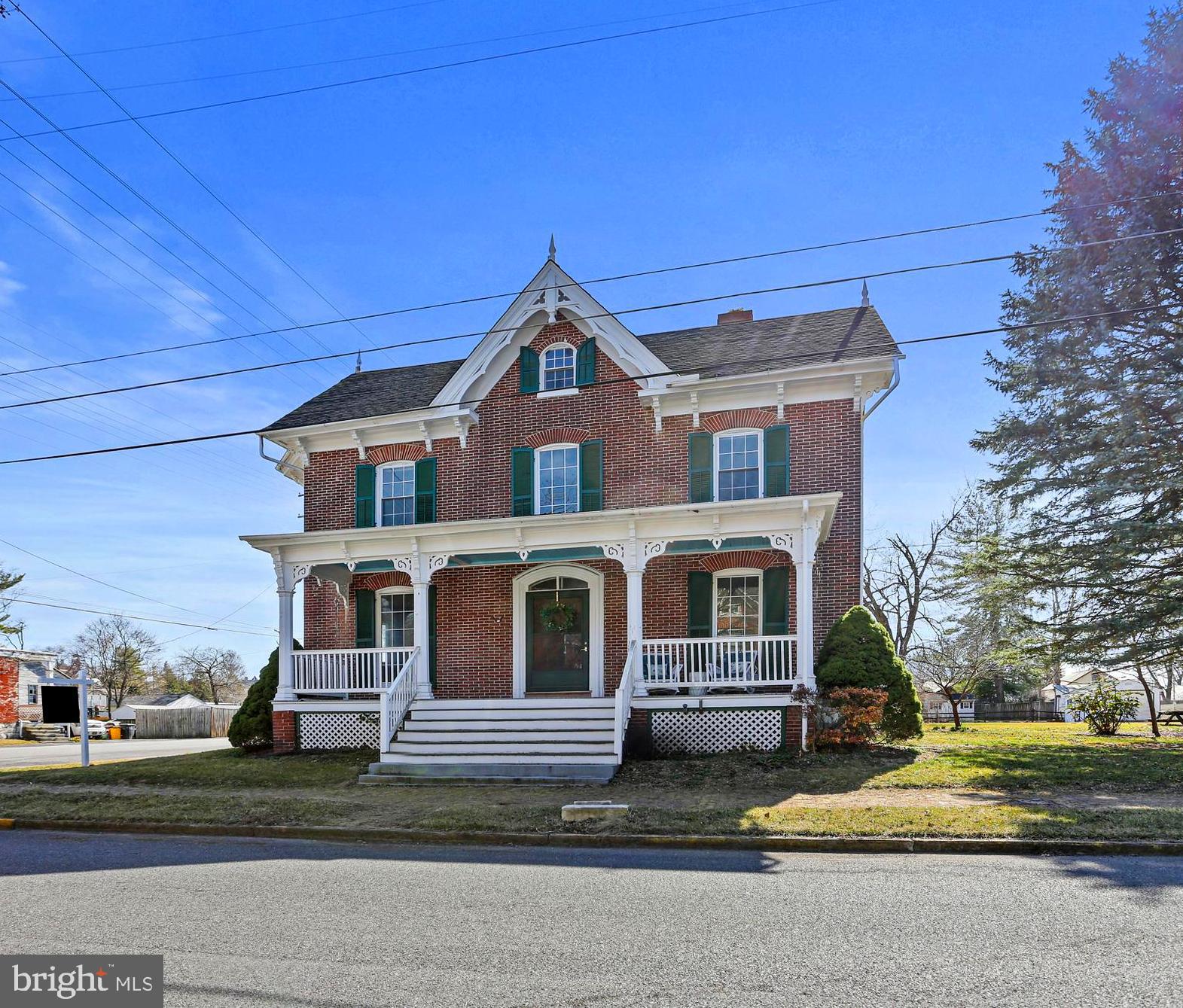 Charming 1850 Colonial on Spacious Corner Lot
Welcome to 33 Broadway St – a stunning 4-bedroom, 2-bathroom colonial with historic charm. Situated on a generous sized lot with a convenient pull-through driveway, this well-maintained gem is a rare find.
Step onto one of the three covered porches to enter the home or perfect for relaxing and enjoying the outdoors. The original brick construction, stone foundation, and newer shingled roof highlight the home's timeless appeal. Inside, you'll be captivated by the home's historic details: original cast iron radiators, intricate wood moldings, perfectly maintained interior shutters, and a striking open staircase. Many rooms showcase gorgeous hardwood floors, 9+ ft ceilings, and a cozy ambiance with wood and marble fireplace mantels. The main level includes a full bathroom for added convenience. Storage is abundant, with ample closet space throughout. Recent updates include a new oil tank, hot water heater, chimney lining, new bathroom flooring (2nd Floor), and wired attic space, offering potential for future living expansion. Additional exterior features include a detached 2-story barn with electricity and a 2-car garage, and an outside garden shed. The walkout basement provides added functionality and storage. This beautiful colonial is being sold strictly AS-IS, presenting a unique opportunity to own a piece of history with modern comforts. Schedule your showing today and fall in love with this timeless treasure!